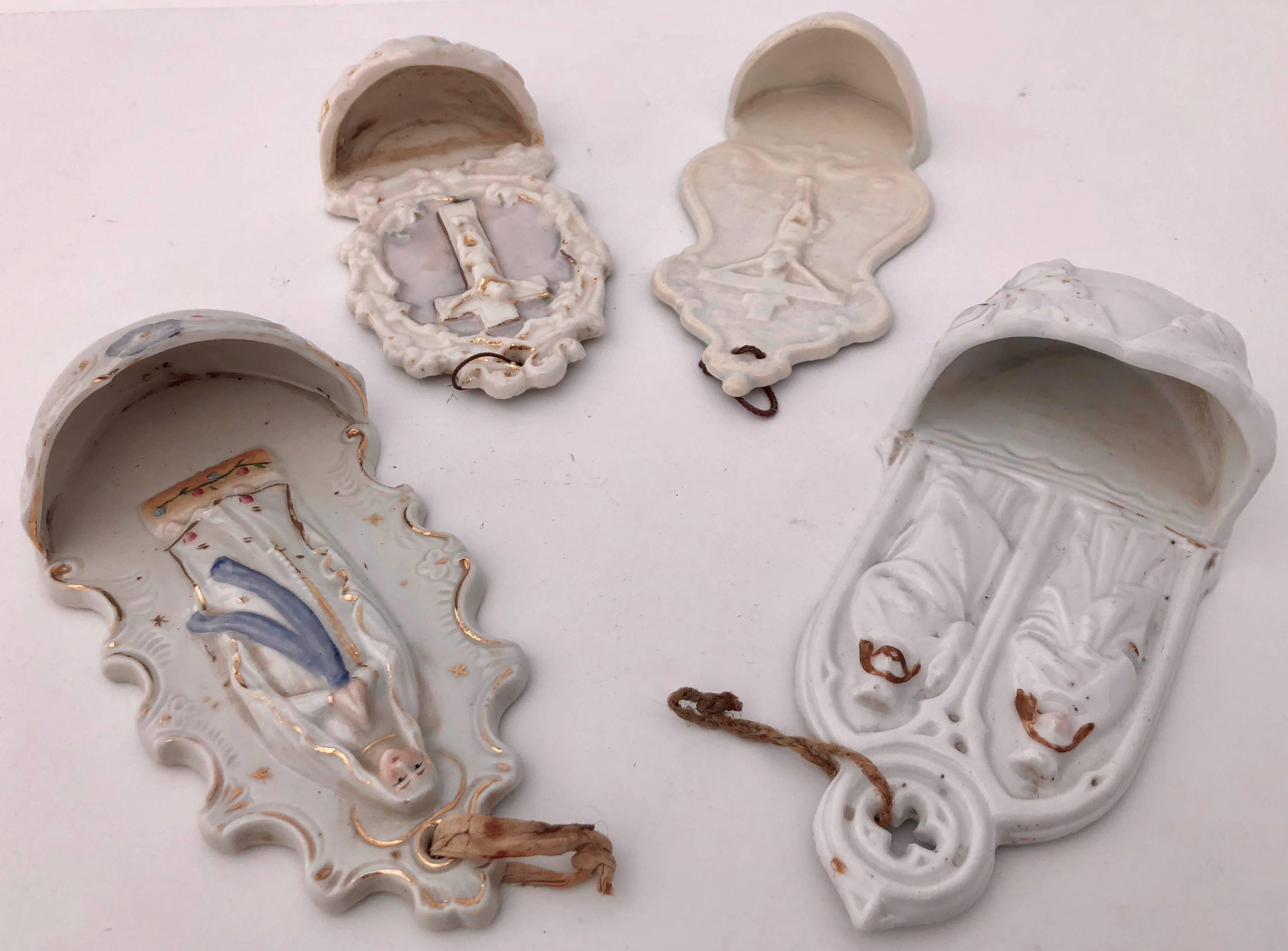 This stunning collection of 4 French antique holy water fonts (bénitiers) are all white with various trim touches. Two are have crucifixes, one is of Mary providing a blessing and one has both Mary and Jesus together. They are all porcelain de Paris