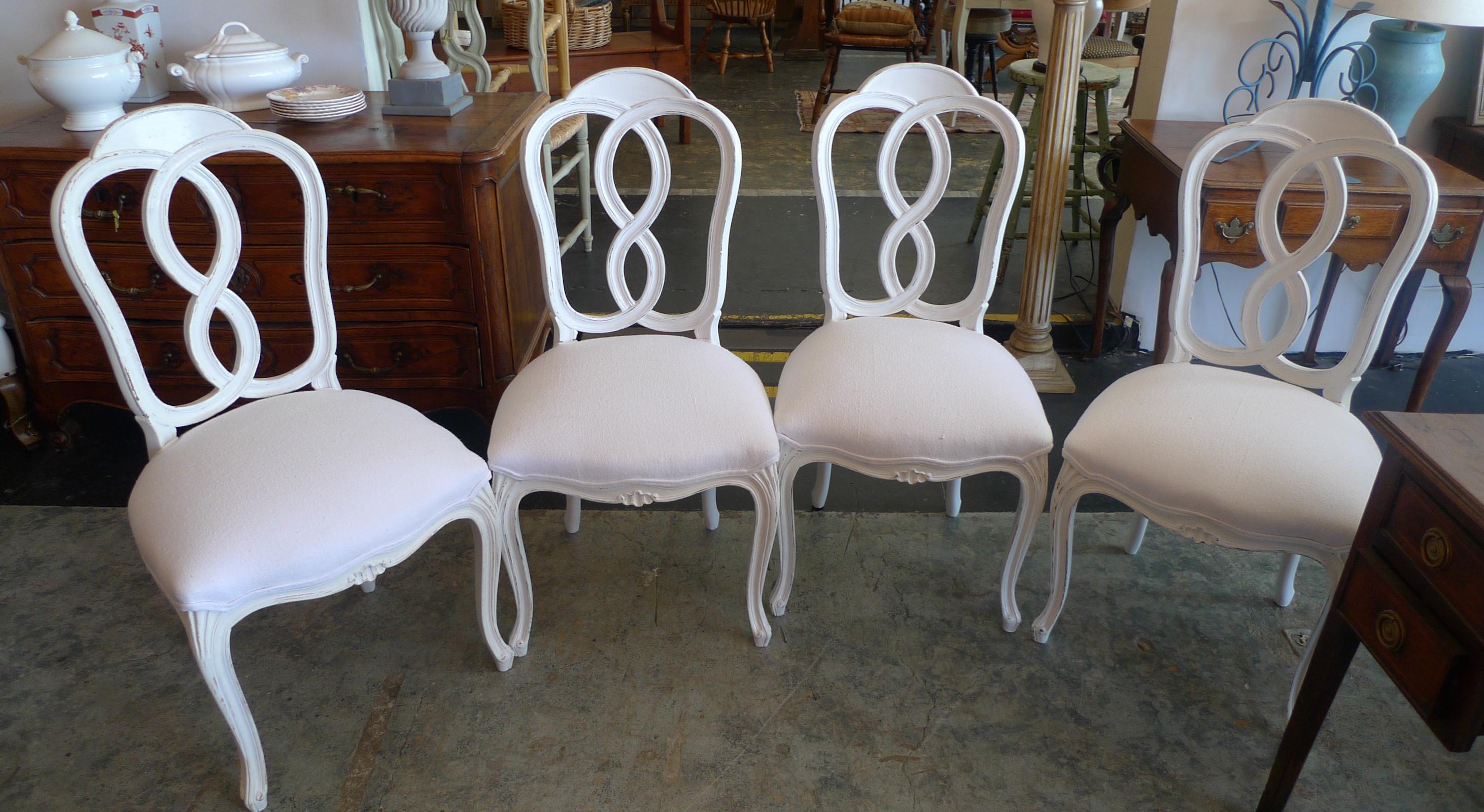 Set of 4 French Louis XV style painted dining chairs reupholstered with vintage fabric.