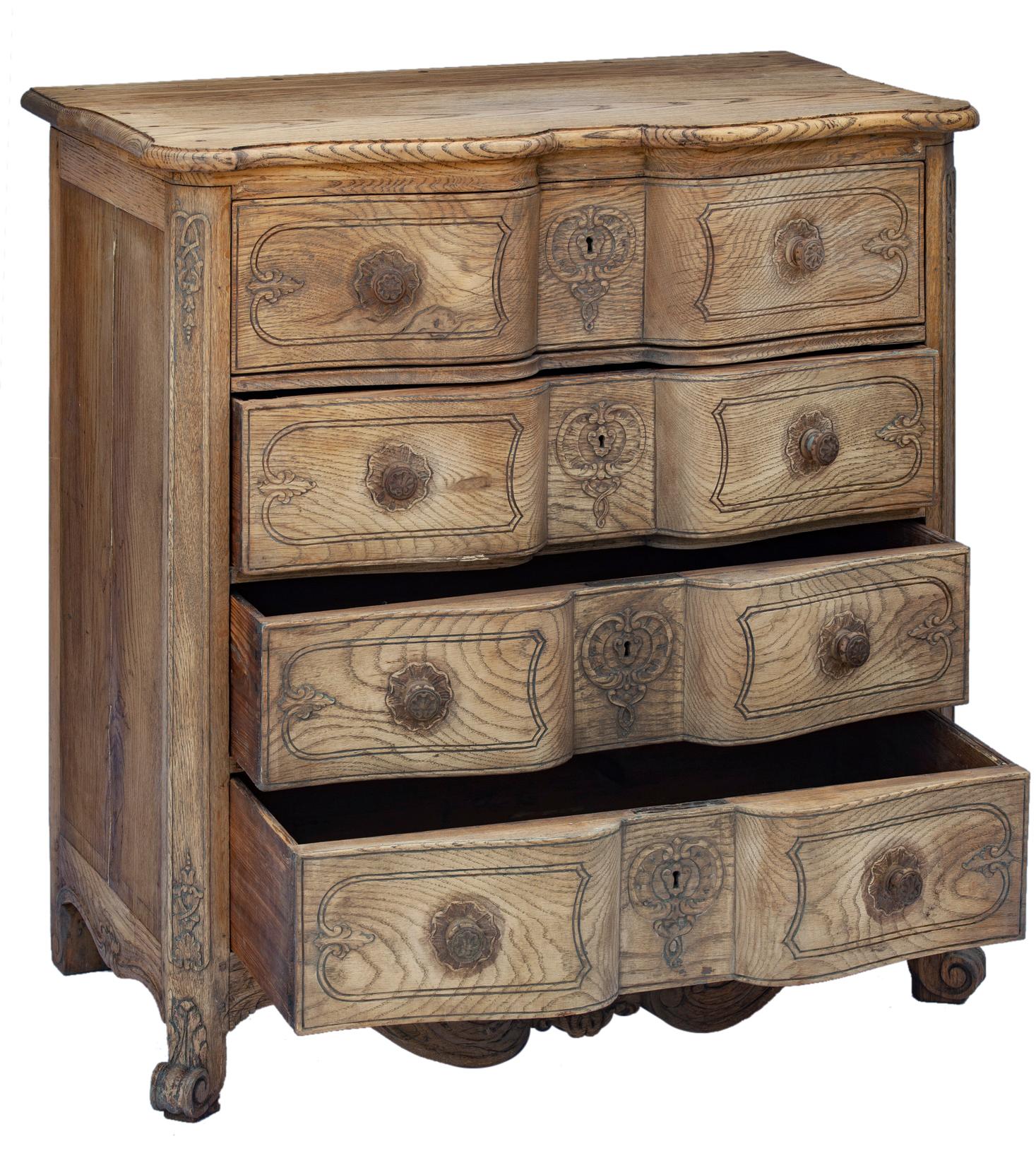Late 19th C early 20th C. hand carved French Oak Provincial serpentine four drawer chest. The drawers are deep & spacious. 
Graceful serpentine profile with shell motif & ornate cabriole front feet.
Bleached & restored with a super smooth