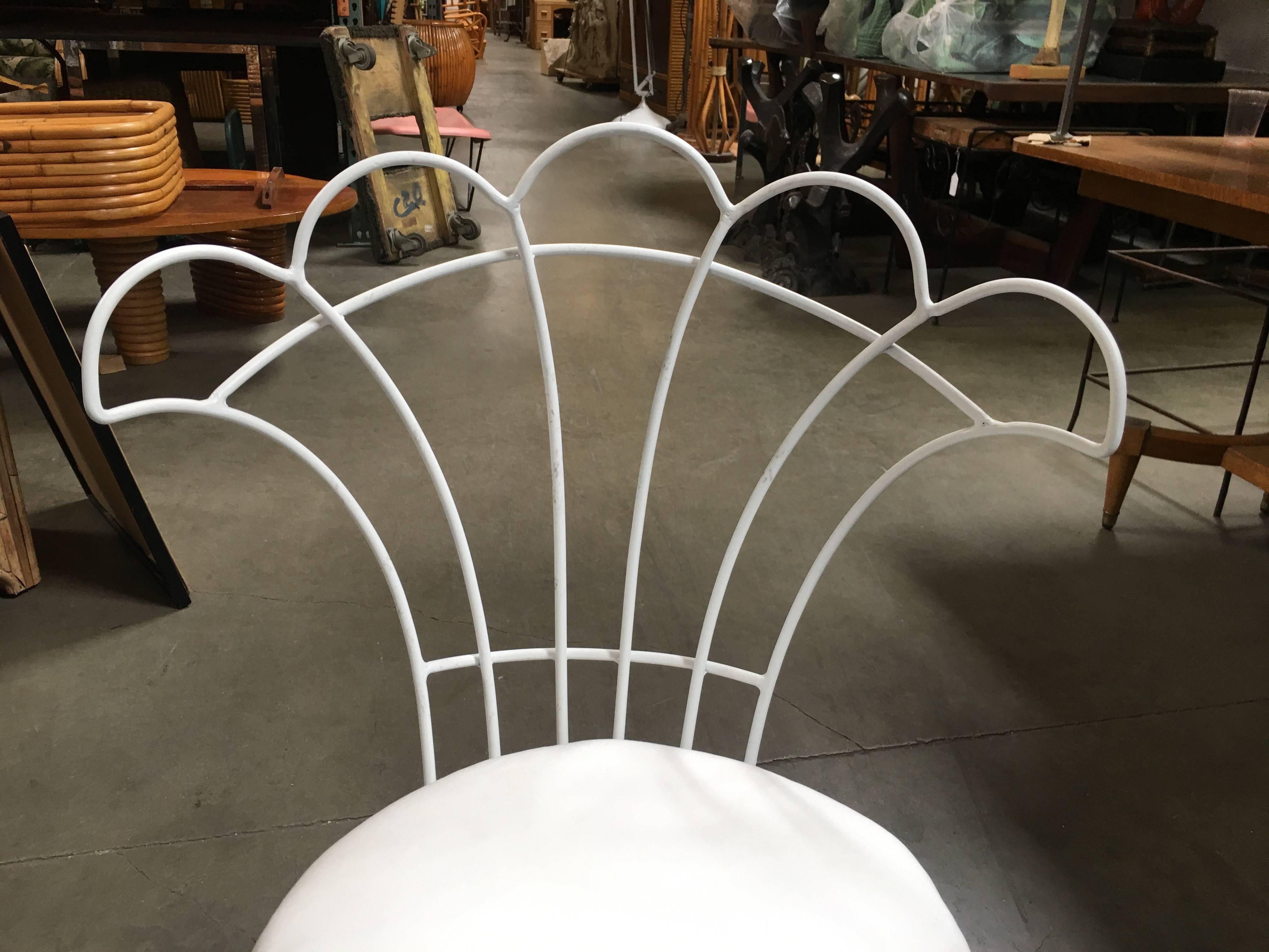 Reminiscent of a Paris cafe, a set of four French wrought iron outdoor/patio chairs with distinct floral inspired fan backrest. This chair is constructed with solid core wrought iron professionally refinished in a pure white Rustoleum finish and a