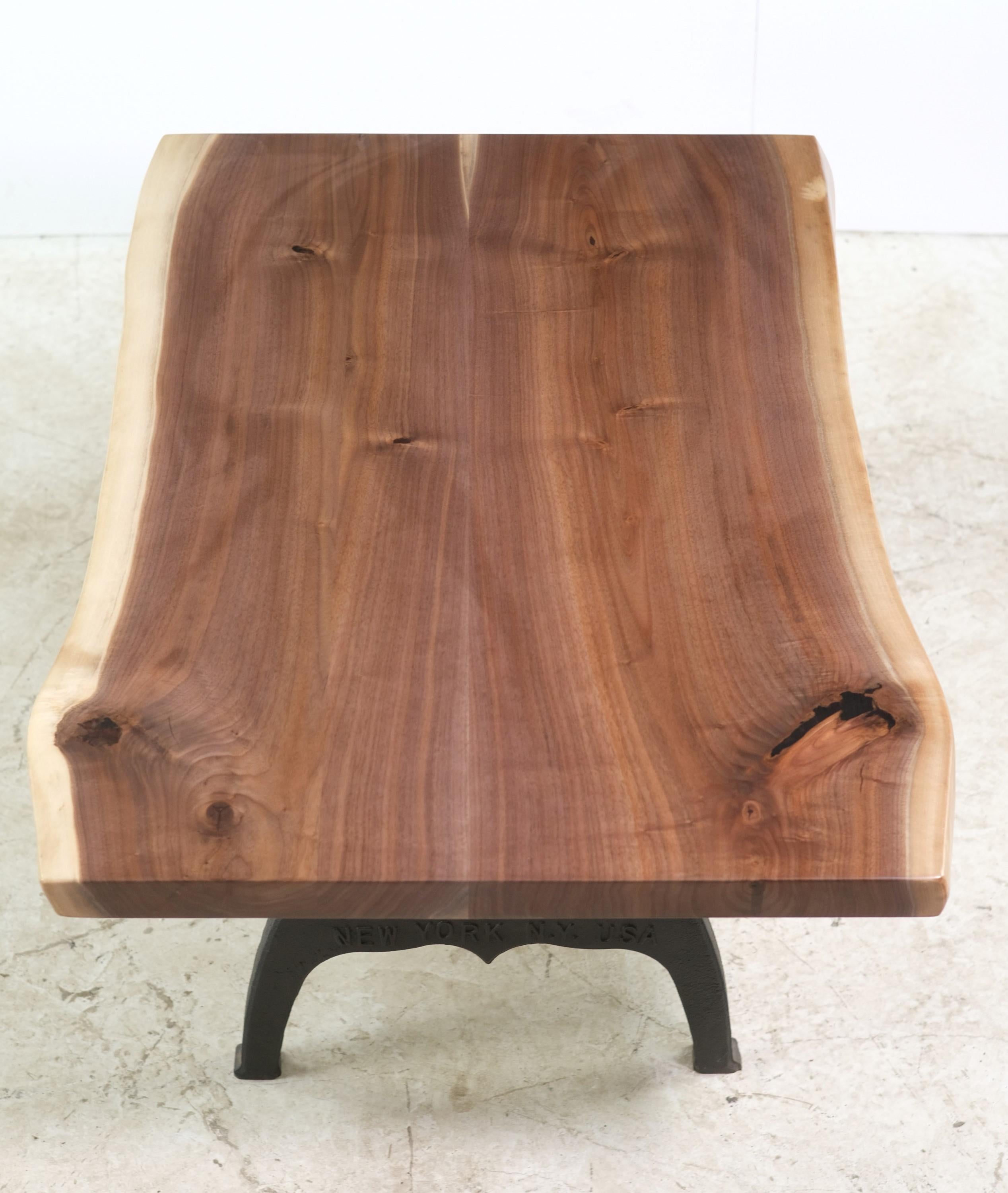 This live edge coffee table features a natural stained two slab solid walnut top paired with Industrial style cast iron New York legs. This table is ready to ship. Please note, this item is located in our Scranton, PA location.