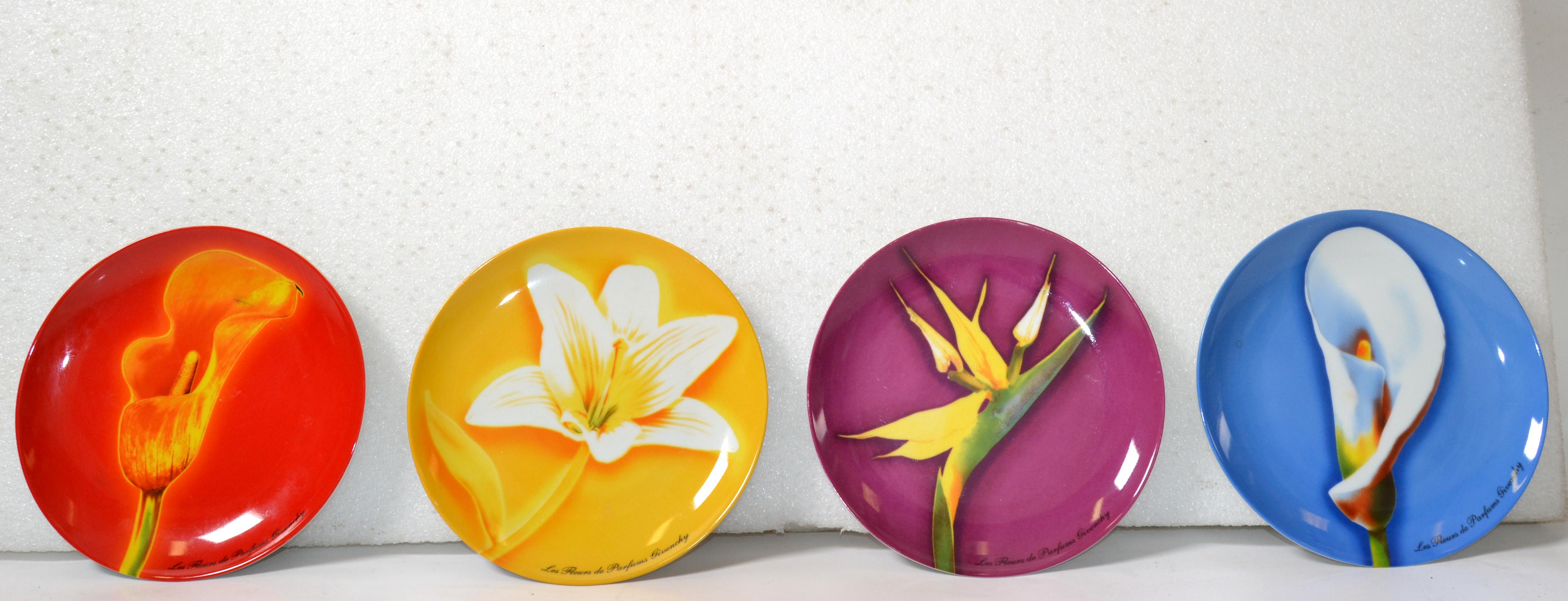 Set of 4 Modern Collectibles plates made for Givenchy Perfumes. Each features a flower used in their fragrances. One is vibrant yellow; the other is bright red, blue and purple. 
Made out of Porcelain and each measure 8 1/4 inches in diameter.