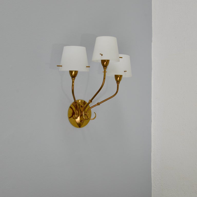 A pair of triple glass shade and brass sconces from 1940s Italy. Fully restored finish. Wired with (3) E12 candelabra based sockets per sconce. Wired for use in the USA. They can also be wired for use anywhere in the world. Lightbulb(s) included
