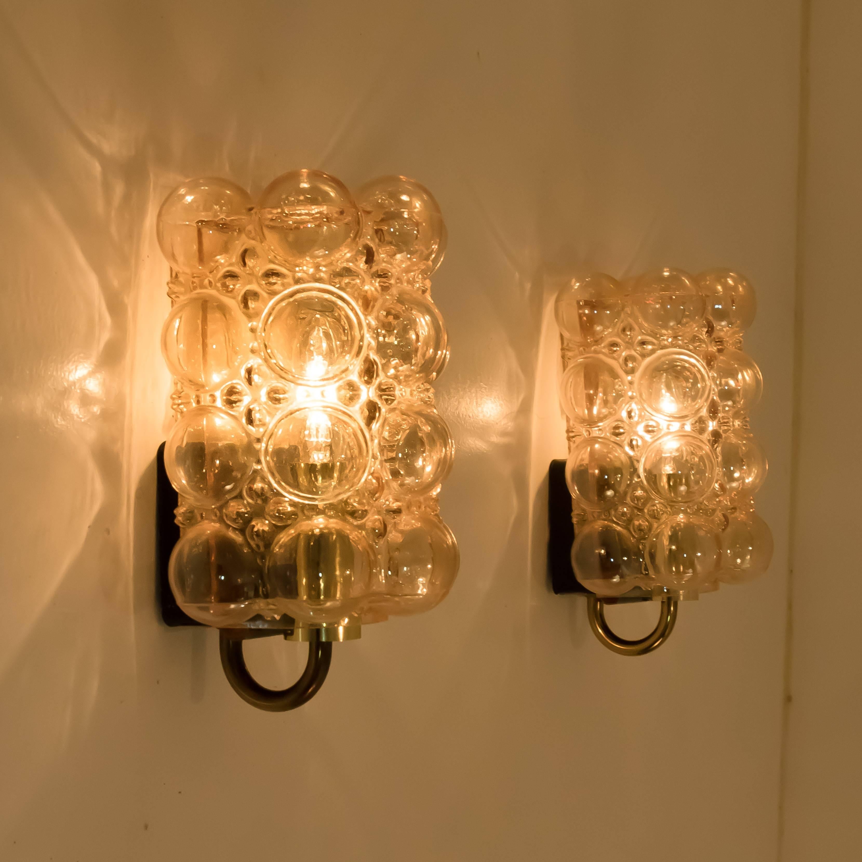 A rare and stunning set of beautiful bubble glass wall lights designed by Helena Tynell for Glashütte Limburg. A design classic, the amber colored or toned of the handblown glass gives a wonderful and warm glow. 

Helena Tynell is a finnish glass