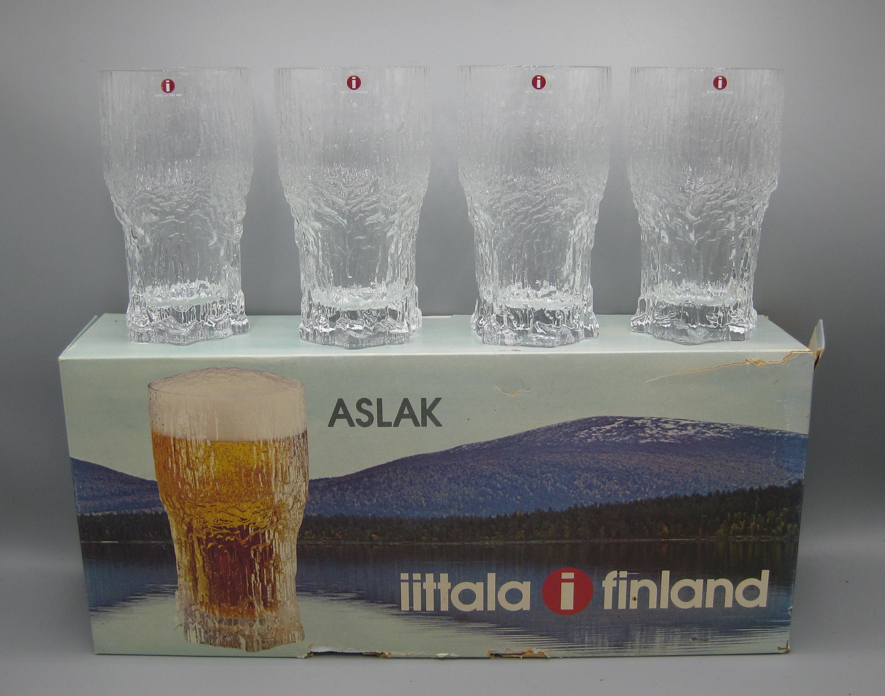 Rare set of 4 original iittala of Finland Aslak 14 1/2 ounce tall beer glasses. and date from the 1960's. These are new old stock and have never been used. They come in the original box and still has the original stickers on each glass. Designed by