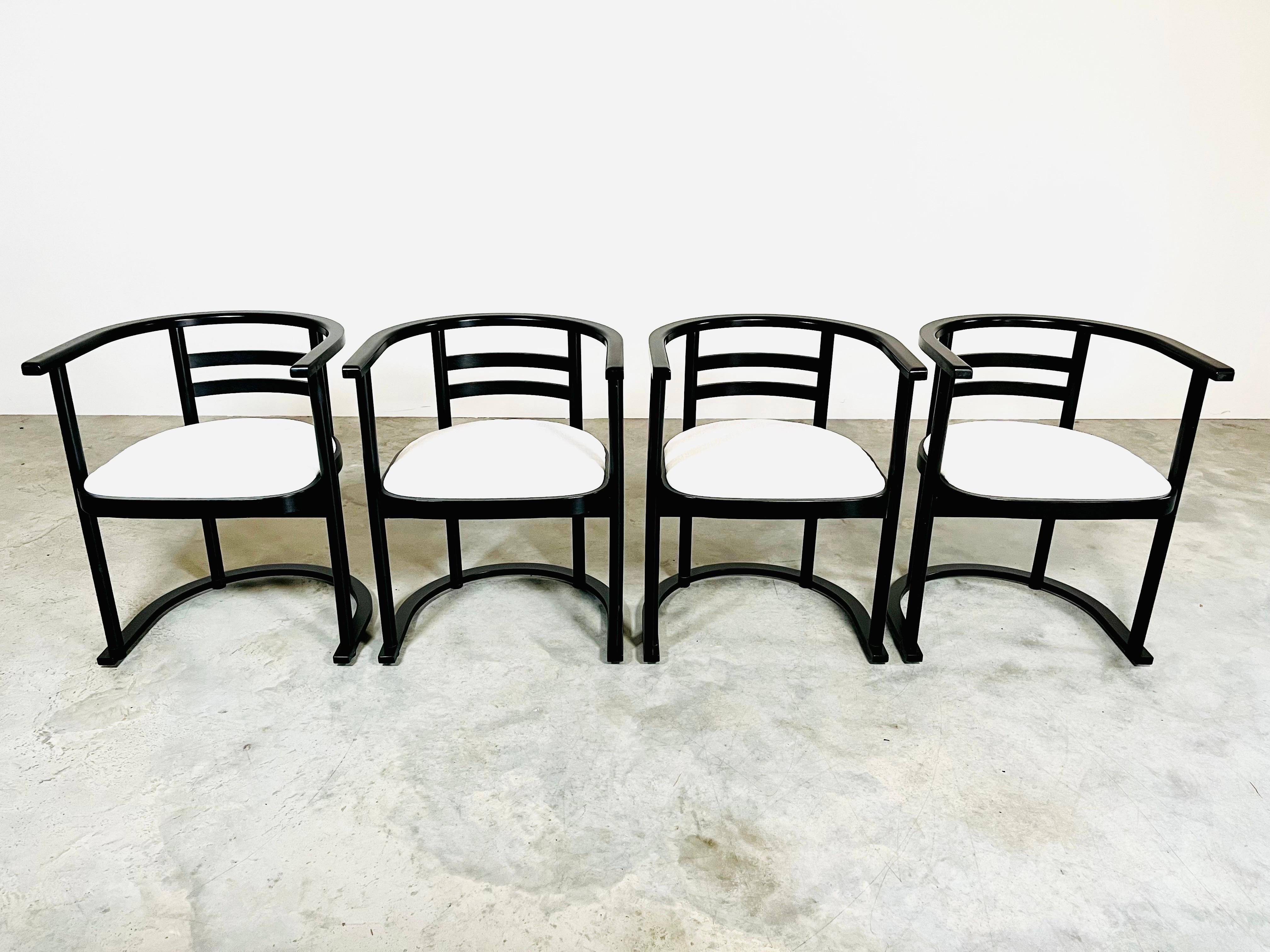 A fantastic set of 4 armchairs in the manner of John R. Eckel Jr. having original black lacquer with brand new cushioning and chenille upholstery. 
 Solid, super comfortable and ready for use. 
The curved backrest offers maximum comfort. 
Made in