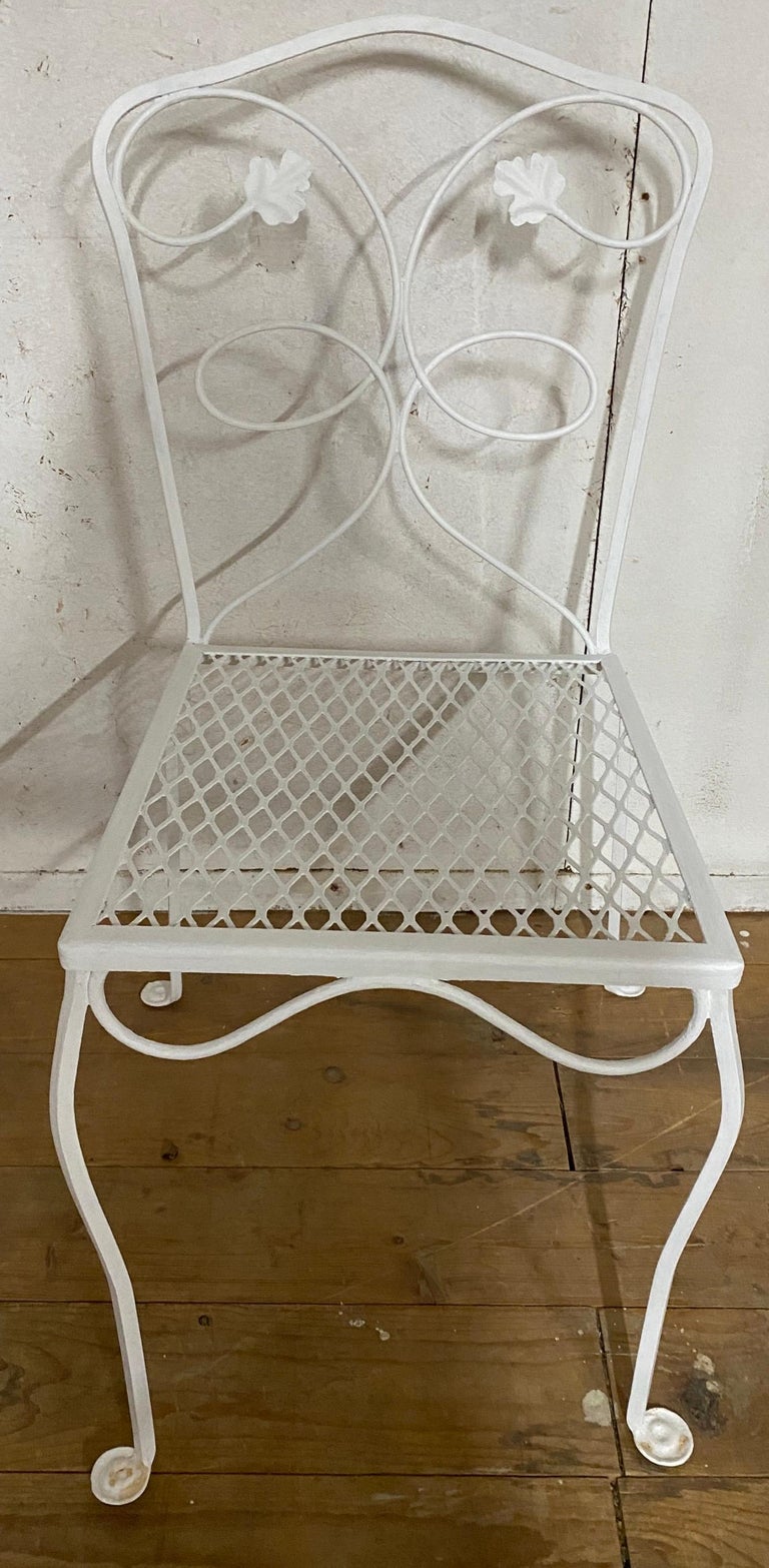 Salterini inspired patio, garden or porch wrought iron dining chairs featuring scrolling maple leaf design, metal mesh seat, quality American craftsmanship, great style and form. Mid-late 20th century.
Measures: Table 48 x 32 x 29.5 H
Chair 16 W x