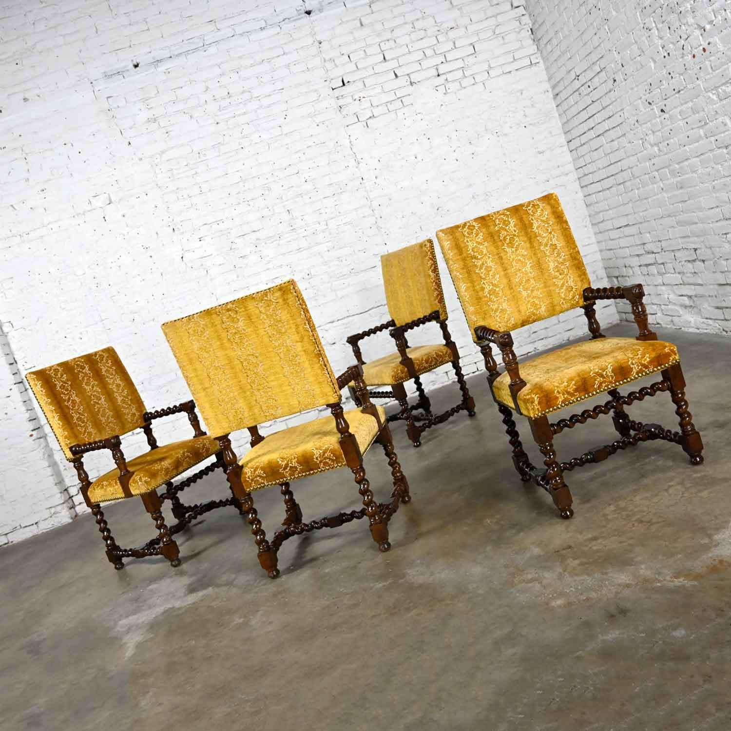 Phenomenal set of four vintage large scale Jacobean style armed dining chairs with Barley Twist frames & gold sculpted chenille fabric with brass nail head trim. Beautiful condition, keeping in mind that these are vintage and not new so will have