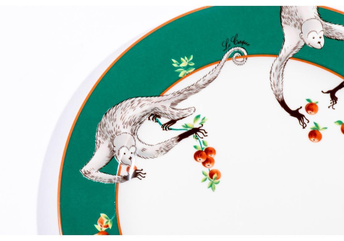 Bernardaud Limoges custom porcelain service plate for Le Cirque Restaurants. The plates with two monkeys picking fruit. Green border, orange trim.
Dimensions: 11 3/4