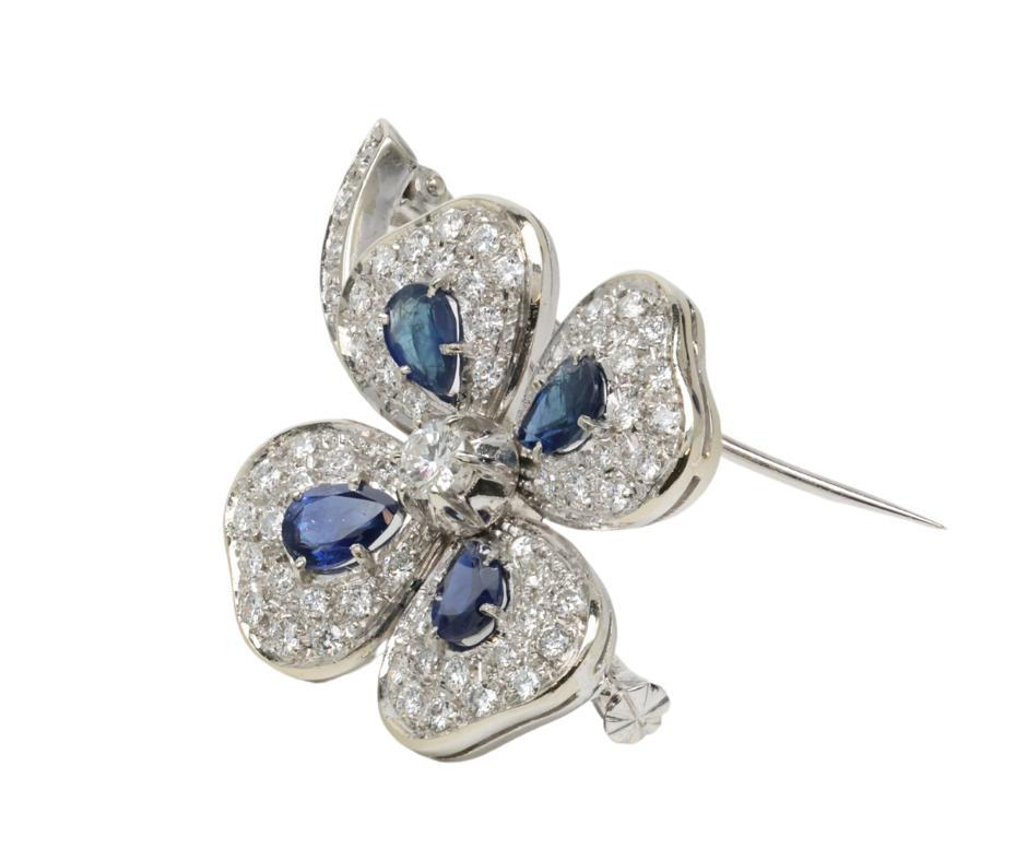 4 Leaf clover Brooch 18k White Gold with Diamonds and Sapphires 

   Brooch 
      Metal - 18K White Gold 
      Weight - 15.2 G 
      Dimensions - 1.5in x 1.25in 

  Stones 
      Diamonds - 2.65ctw
      Shape - Round Brilliant 
      Color - G