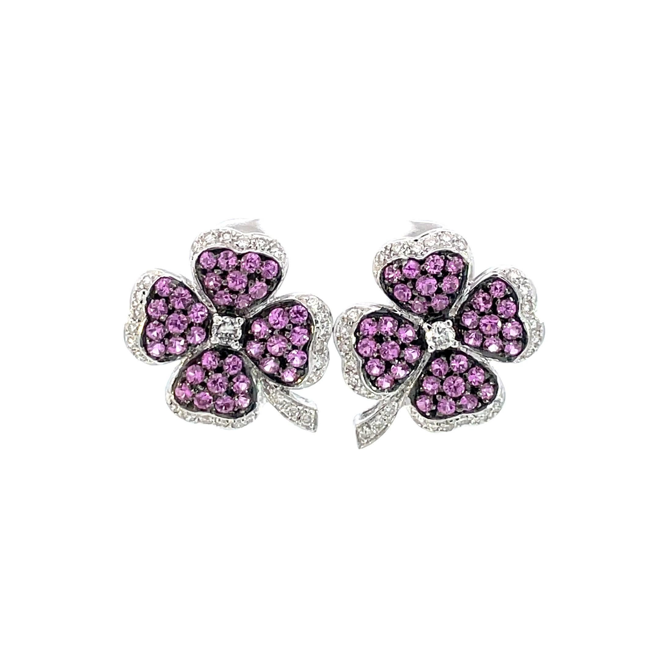 A pair of 4 leaf clover earring set with natural pink sapphires with a black rhodium finish that gives a magnificent contrast  to the natural diamonds set around. Finished in the back with a beautiful honeycomb à jour, straight post and omega clip