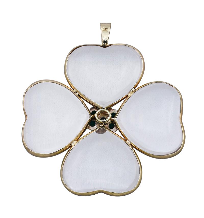 Large and spectacular four-leaf clover pendant.  Four rock-crystal heart-shaped clovers, set within  14K yellow gold borders.  In the center is a bright diamond surrounded by six brilliant faceted emeralds.  1 3/4