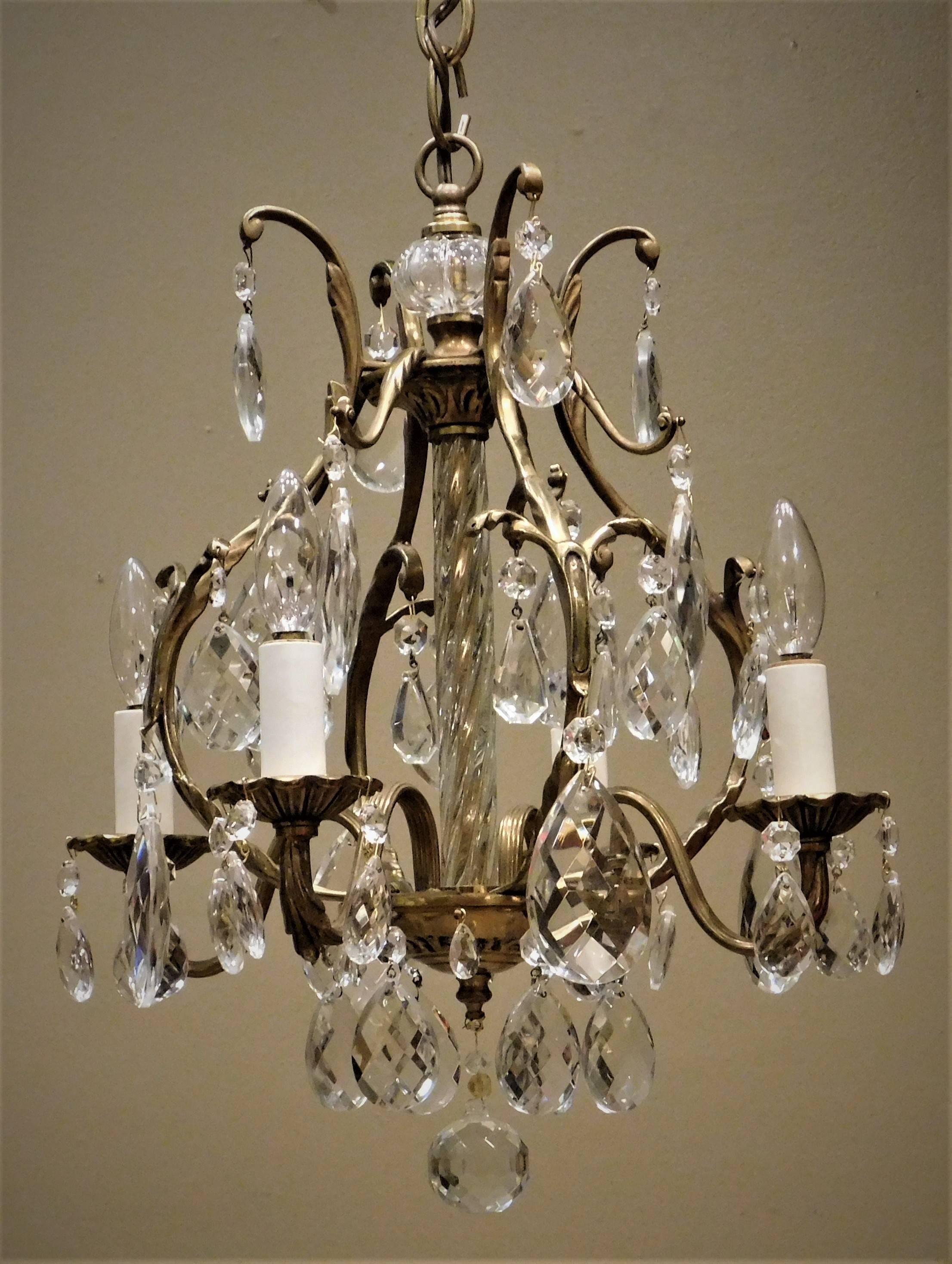 Small chandelier. Hand-cast brass with handblown glass and Swedish hand-cut crystal. Diminutive size makes this chandelier perfect for powder rooms and dressing rooms. Ceiling cap, hanging hardware, and 1' of chain included.