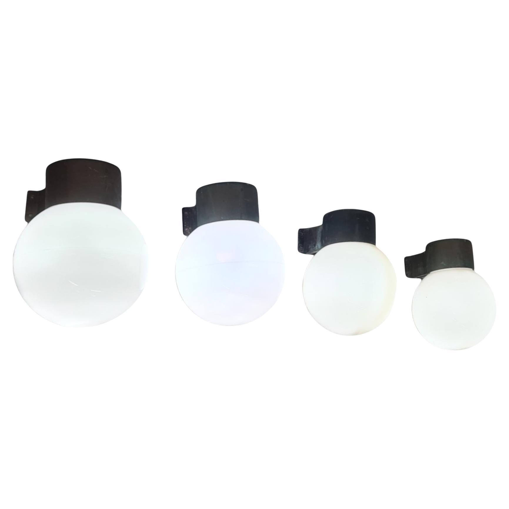 Two pairs (4 lamps) of wall mounted lamps model 17-037, designed by Lisa Johansson-Pape and manufactured by Orno Oy in Finland in the 1960s. Each lamp features a heavily patinated copper metal base with an opaline glass shade. 

They have kind of a