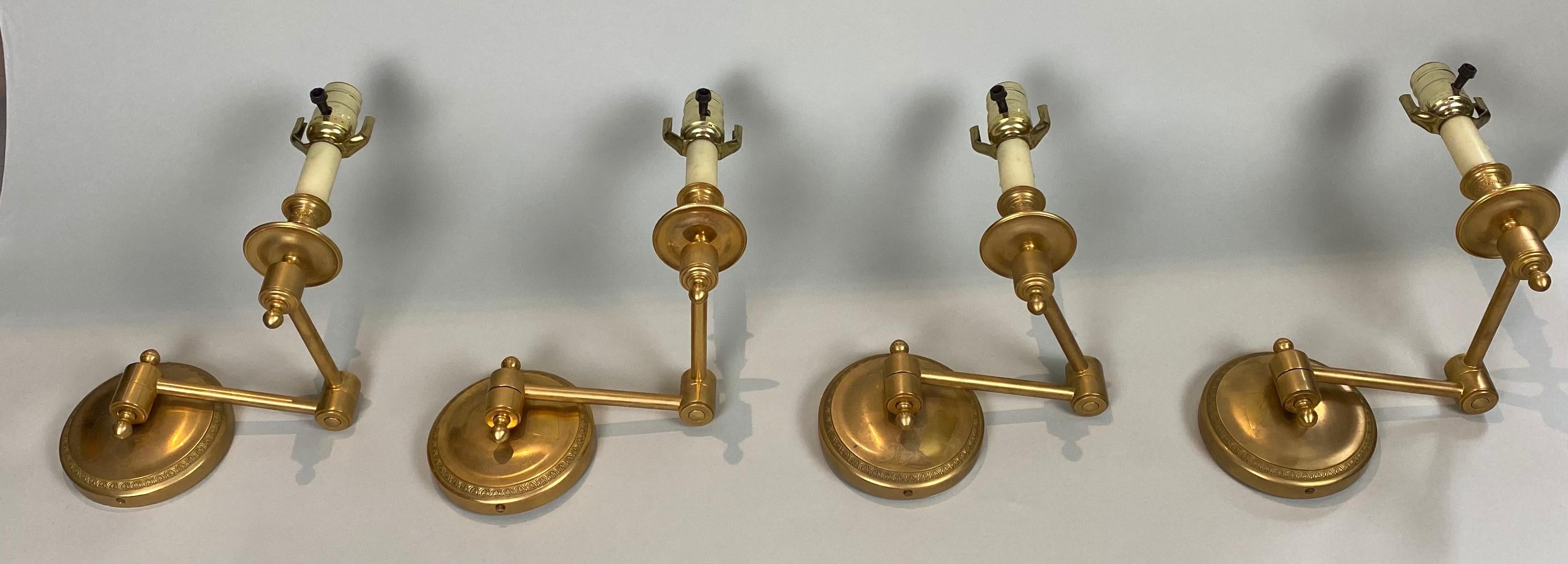 Two pairs of swing arm wall lights, made in France and attributed to Tisserant. Gold Plated Bronze Finish. Unsigned. Available as a set of 4 or by the pair. Please note, one back has slight cutout visible in photo. Diameter of backplate 5 inches.