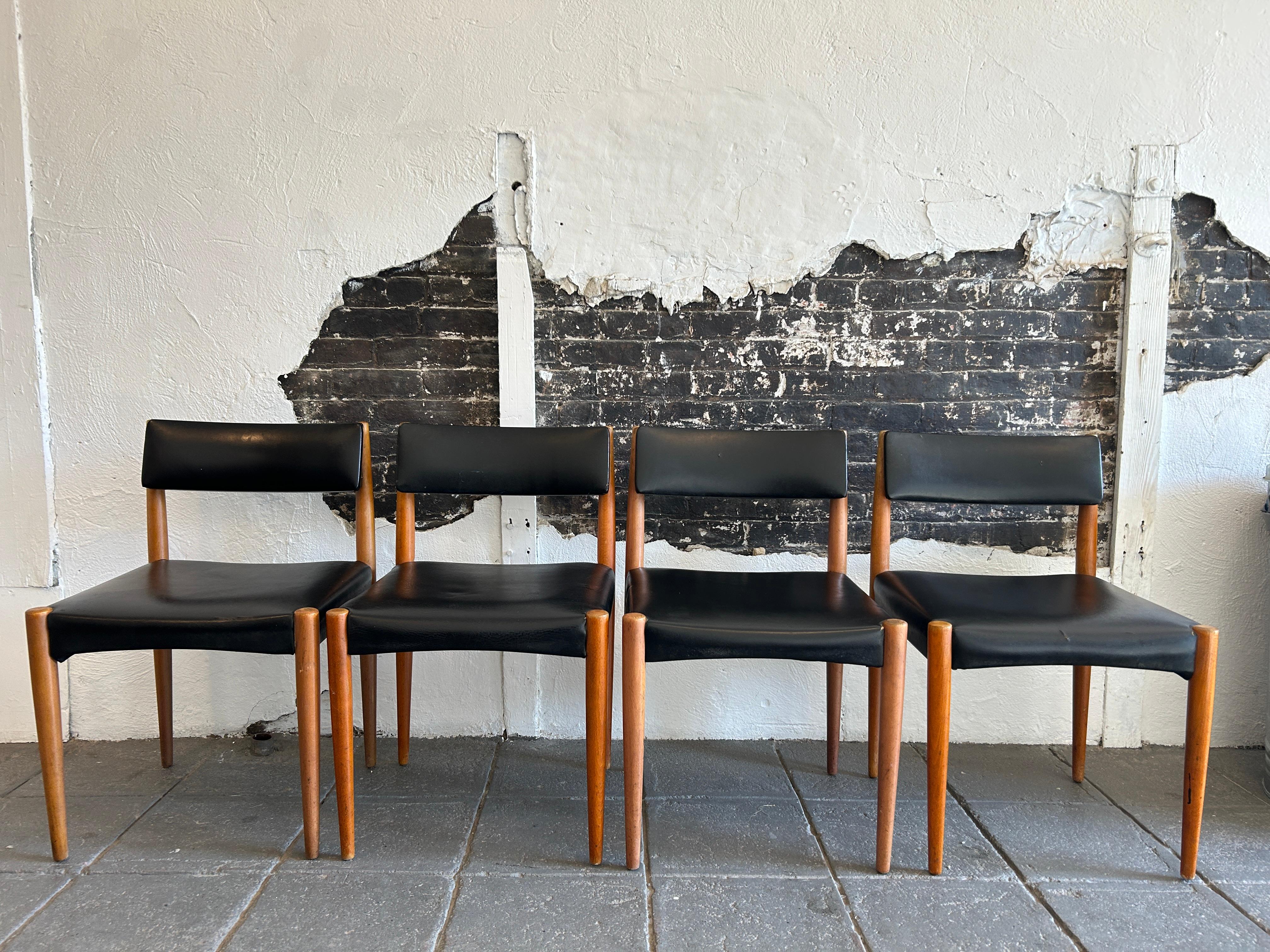 Set of 4 mid century danish modern dining chairs. Simple design with slanted back support. 4 tapered birch legs with black vinyl cushions. Use as is or have them reupholstered. Great design. Circa 1960 made in Denmark. Located in Brooklyn