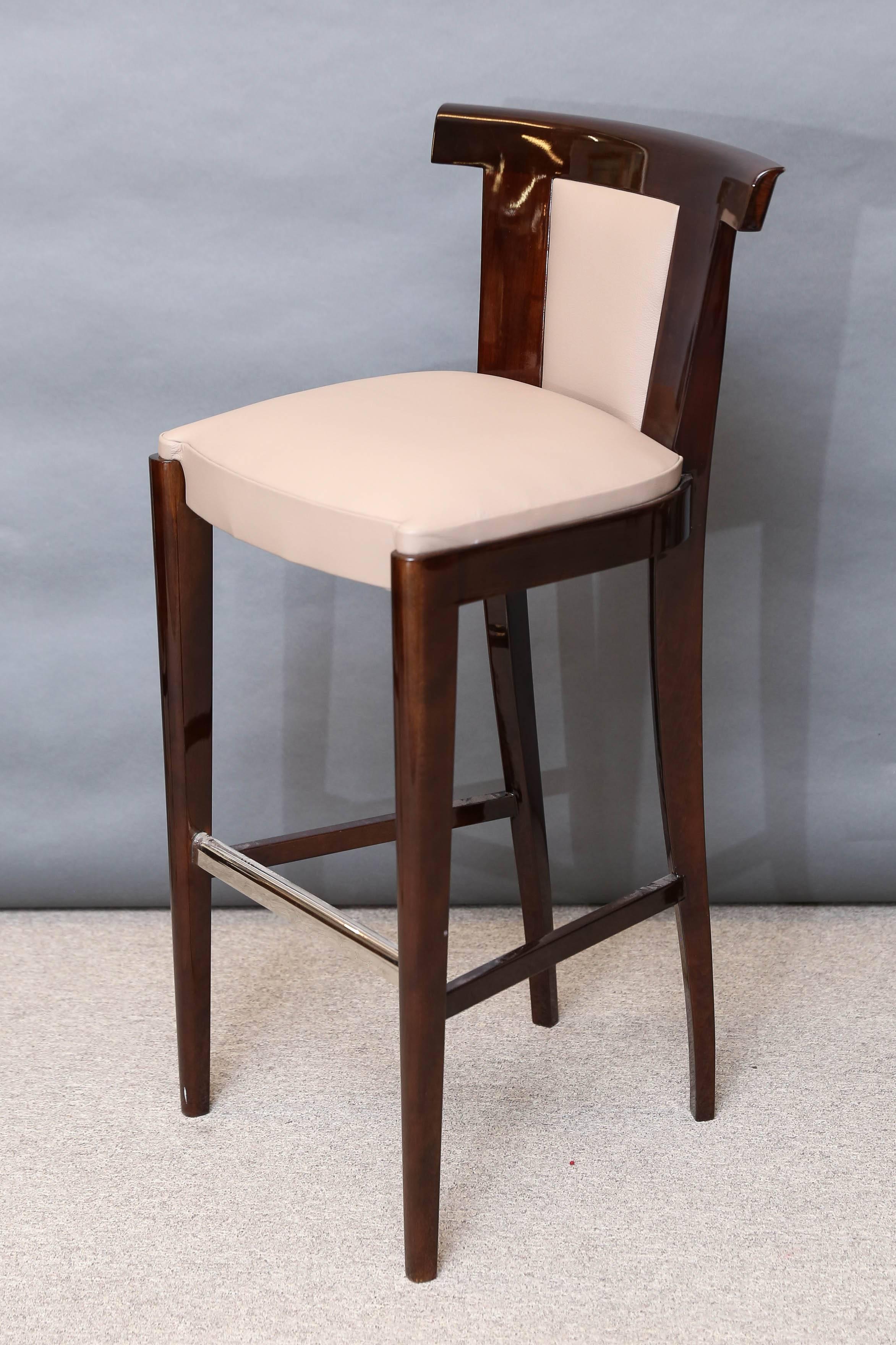 High gloss walnut veneered bar stools. 
Having chrome foot guards on foot rests, and chromed front legs for protection.
Re-upholstered in a new cowhide.
 Condition is perfect. Restored.
Could be sold separately. 
 France, circa