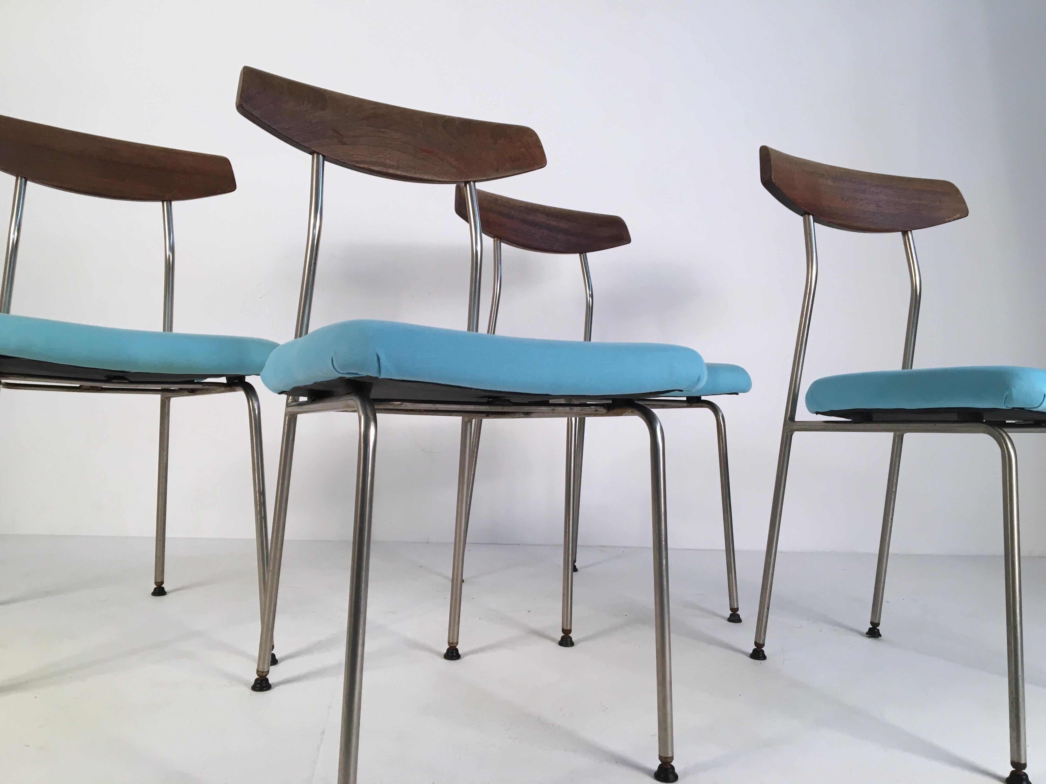 Set of 4 dining chairs designed by John and Sylvia Reid for Stag in the 1950s. Solid teak backrests sits on steel frames supporting a padded blue upholstered seat.
 