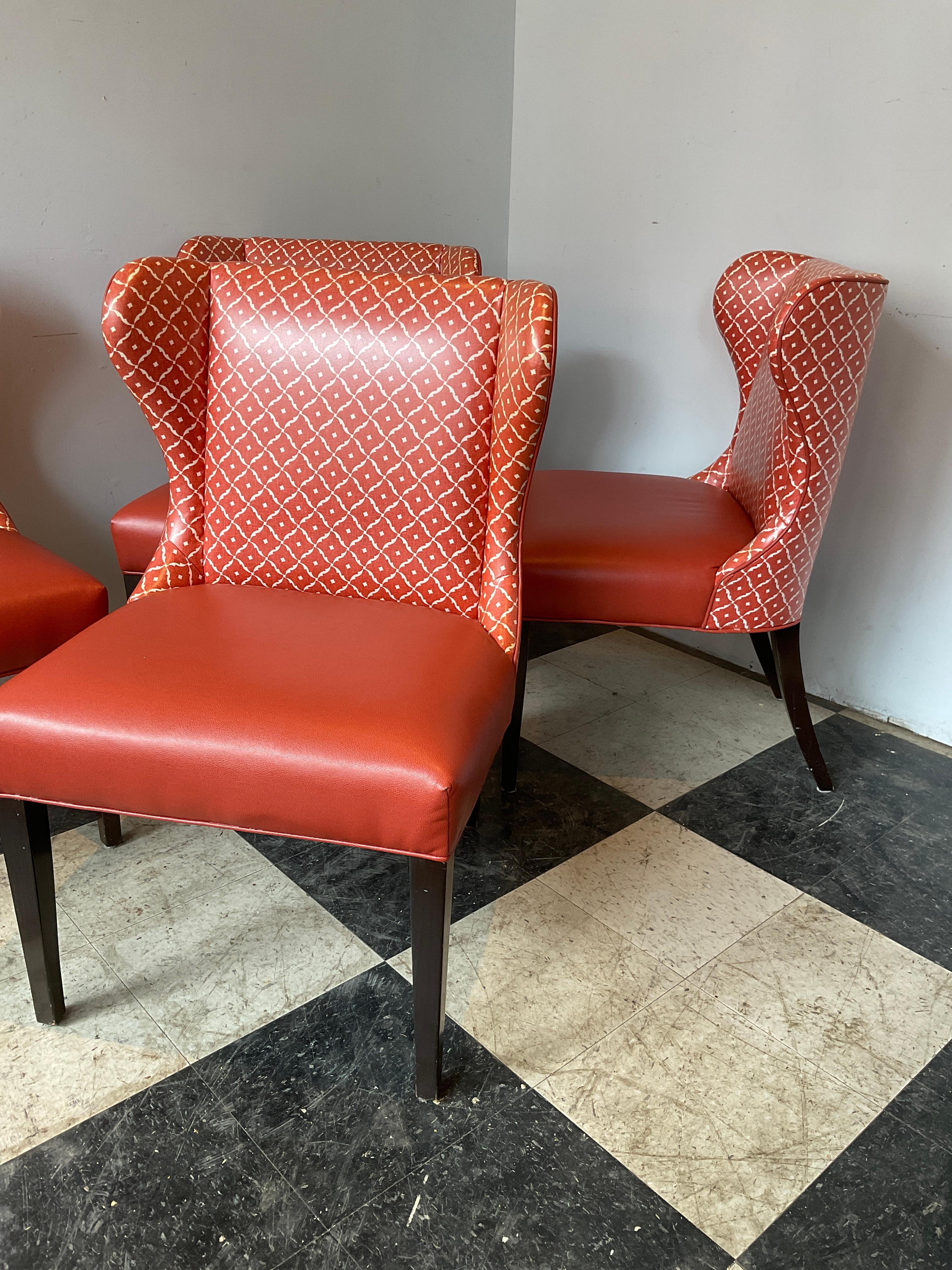 4 Orange modern wingback chairs. Faux leather seats are in good condition, rest of chair should be reupholstered.