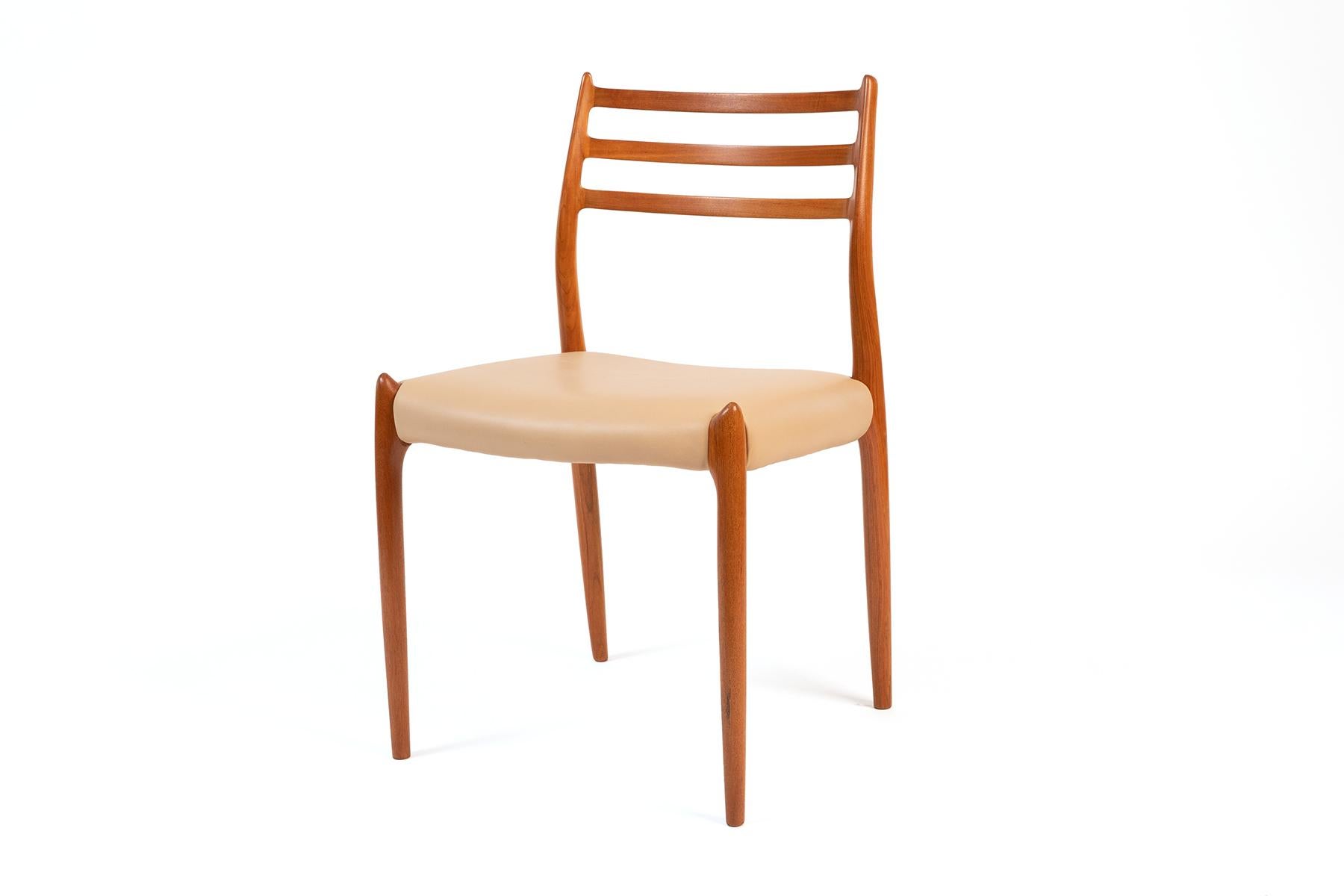 Set of four dining chairs by Niels Otto Moller for J.L. Moller, Denmark circa mid 1960's. Model 78. A stylish set of teak chairs with leather seats and sculpted ladder backs. Newly finished and upholstered. Price listed is for the set of four.