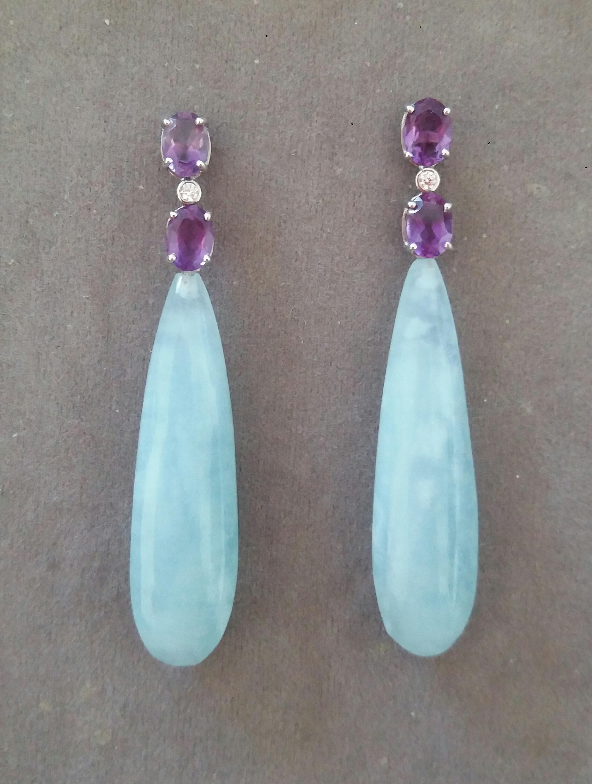 Elegant and completely handmade Earrings consisting of an upper part of 2 oval shape faceted Amethyst of 5 x 7 mm set together in 14 Kt white gold with a  small diamond in the middle, at the bottom 2 Aquamarine Plain Round Drops measuring 12x43