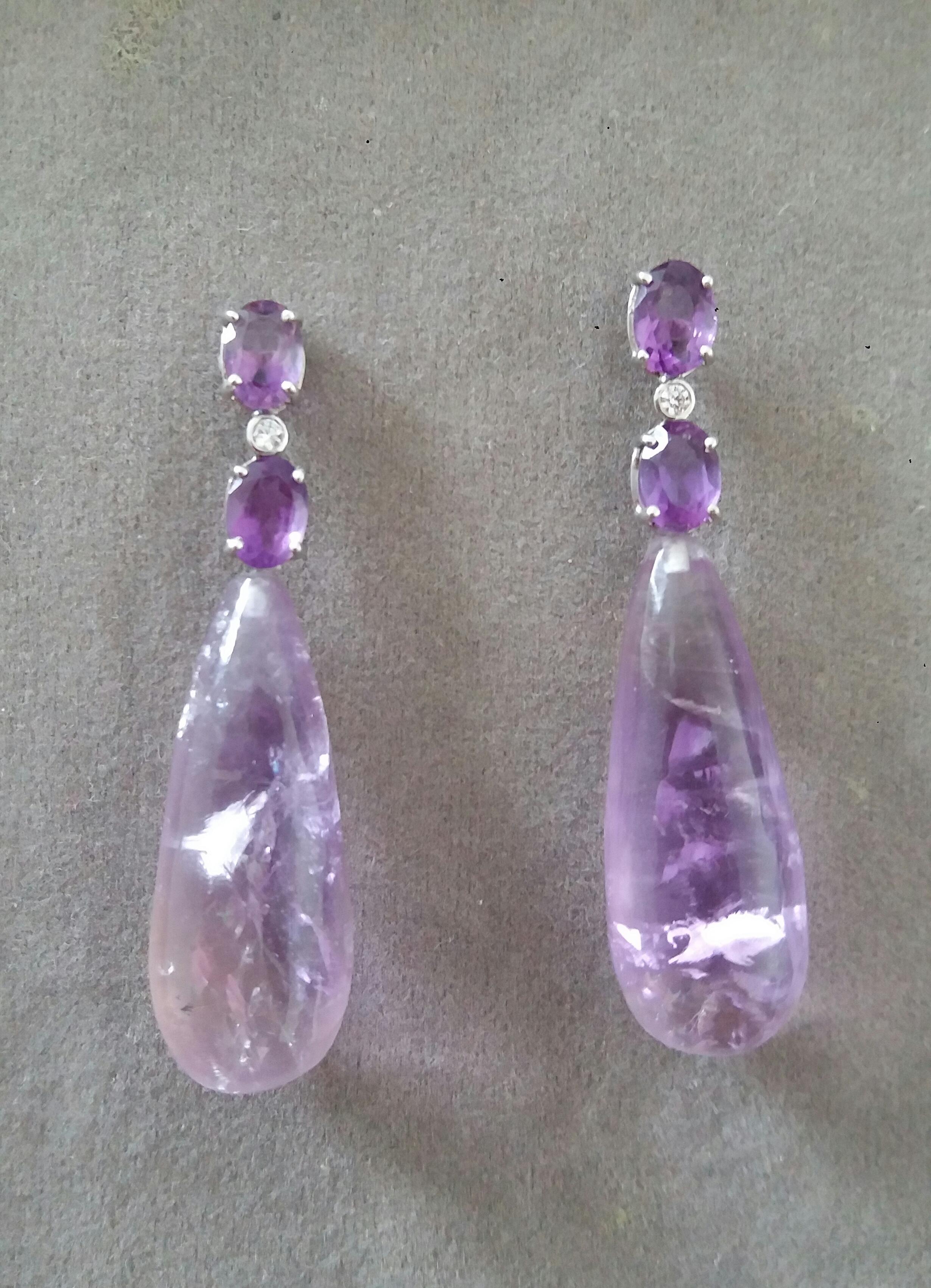 Elegant and completely handmade Earrings consisting of an upper part of 2 oval shape faceted Amethyst of 5 x 7 mm set together in 14 Kt white gold with a  small diamond in the middle, at the bottom 2 Amethyst Plain Round Drops measuring 12x43