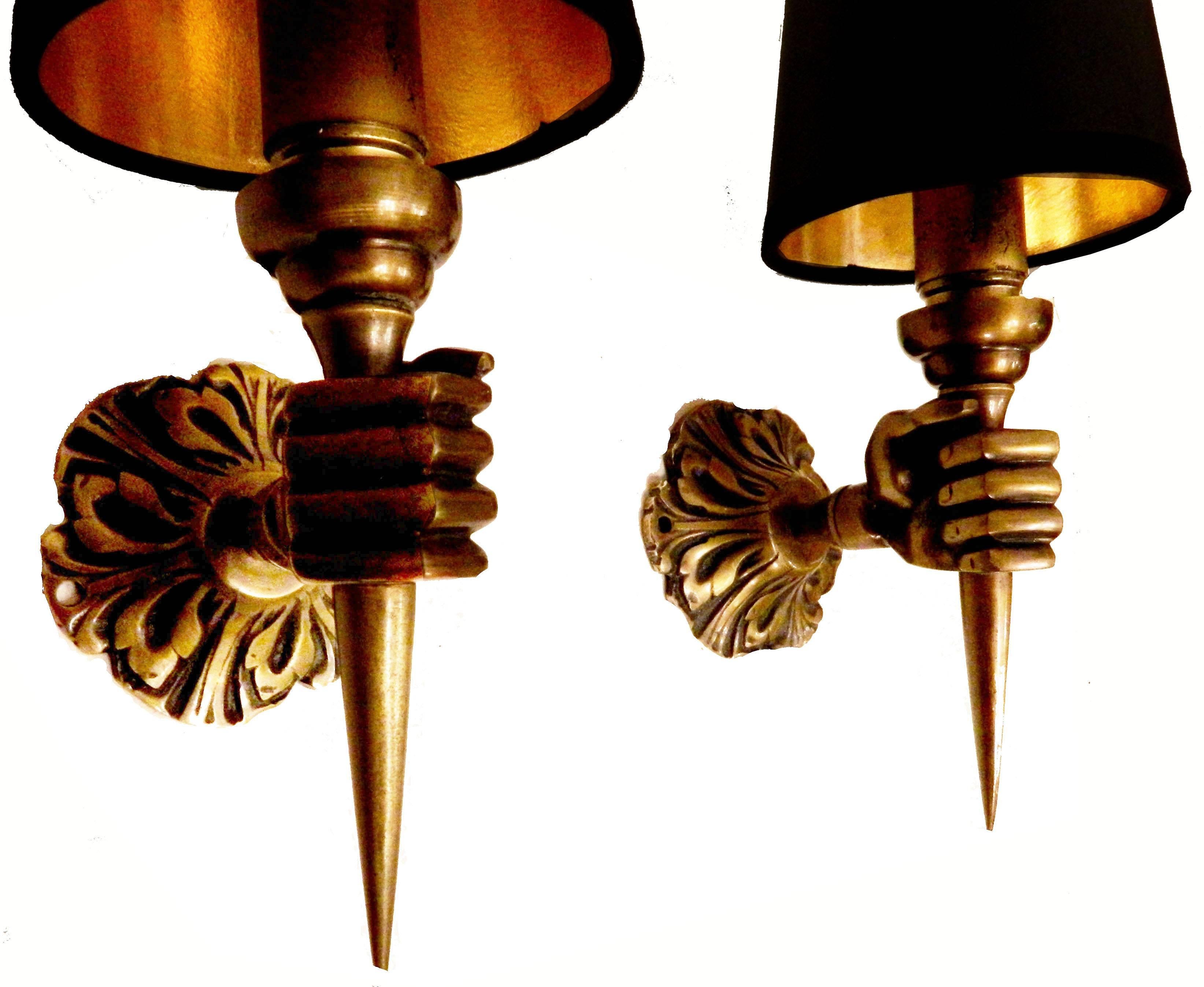 4 pairs of brass ARBUS brass French sconces featuring a hand holding a torch. Opposite hands, circa 1940s.
1 pair in silver opposite hands (last image)
Measurements:
Projection to the wall 4.5