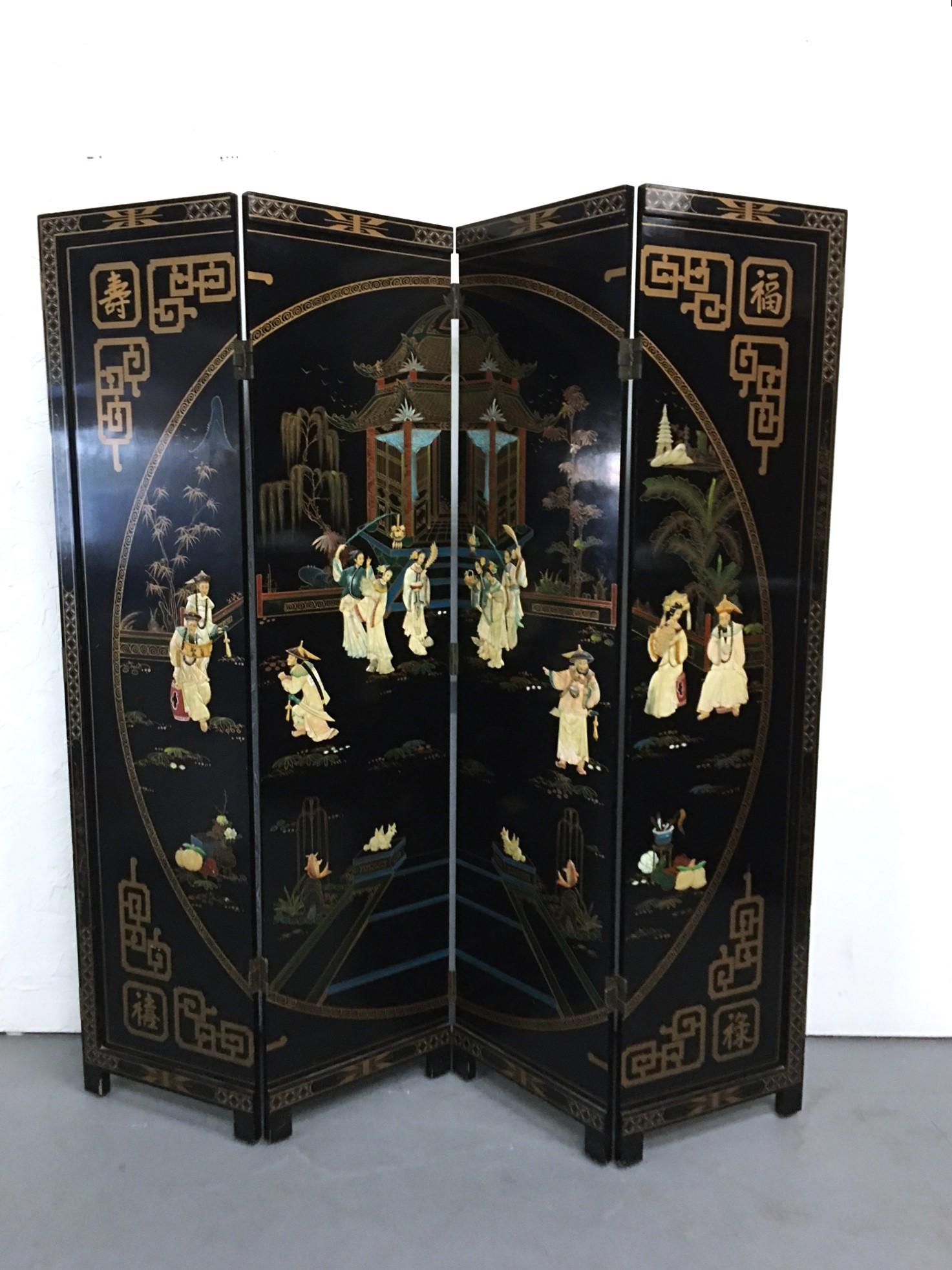 This vintage wood 4-panel lacquered Asian room divider is beautifully carved and painted on both sides. Each side displays a different scene, one side for flowers and the other side for the imperial women and men in a garden scene. Standing on