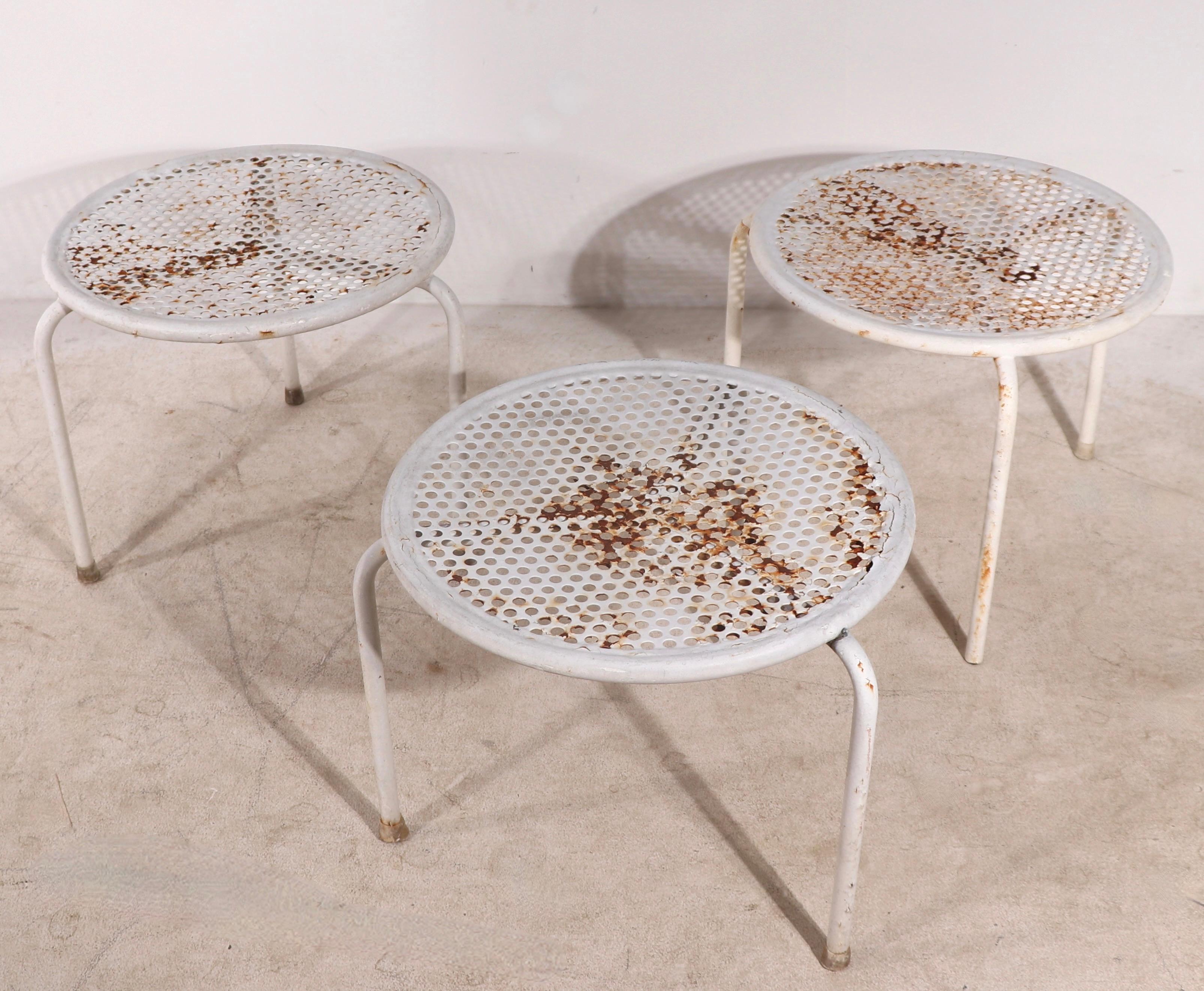 Set of four garden, patio, poolside tables by noted Italian maker, EMU circa 1960's.
 The set consistent of one larger table (23.5 diameter x 18 height inches) and three smaller tables (16 diameter x 13.5 height inches). All four are structurally