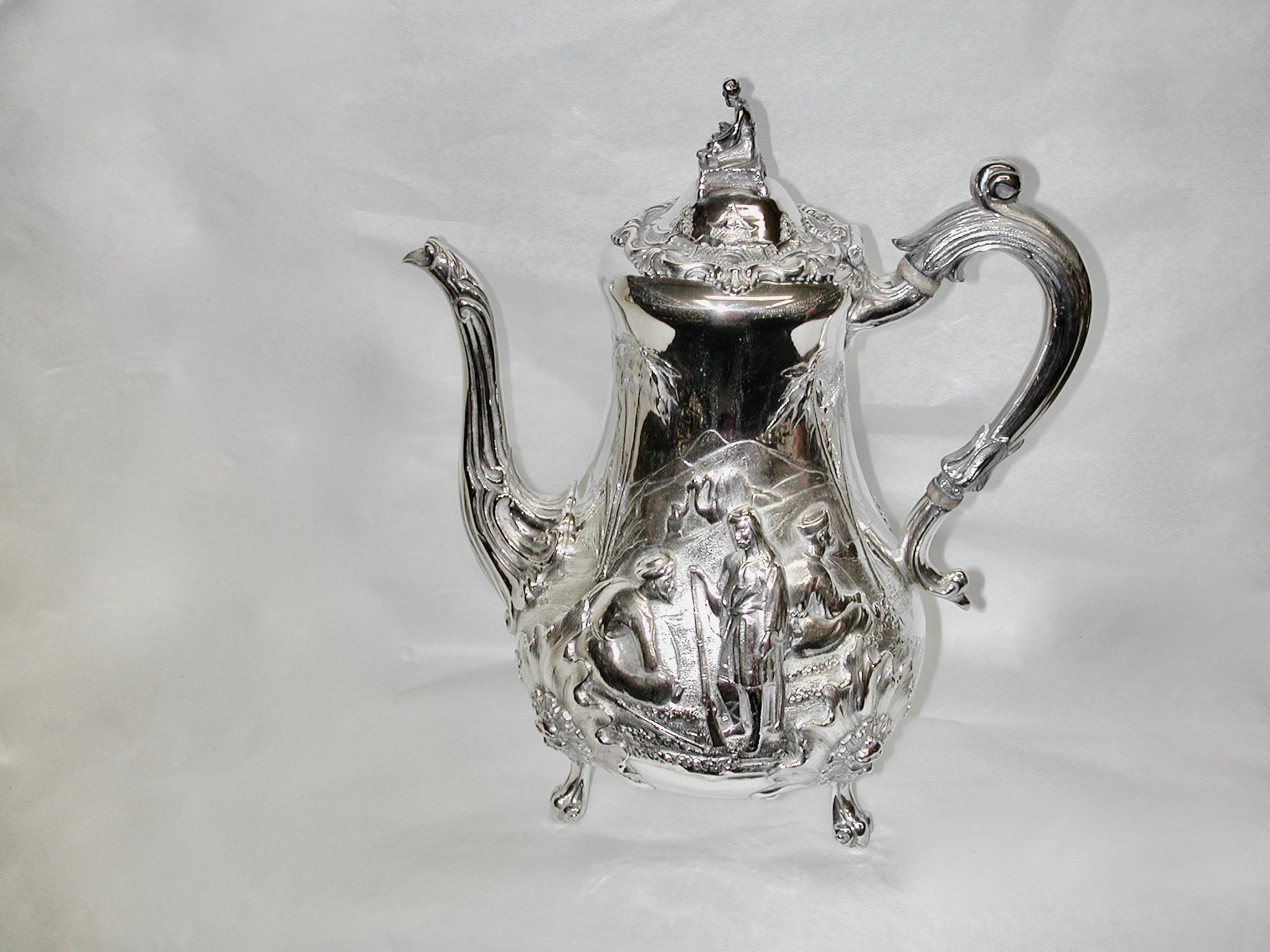 4 Piece Scenic Victorian Silver Tea & Coffee Set Robert Harper 1862/63 London.
Each piece has a wonderful scene appertaining to what goes into it, along with lovely chasing on the other side.
The coffee pot has a arabic coffee traders scene in