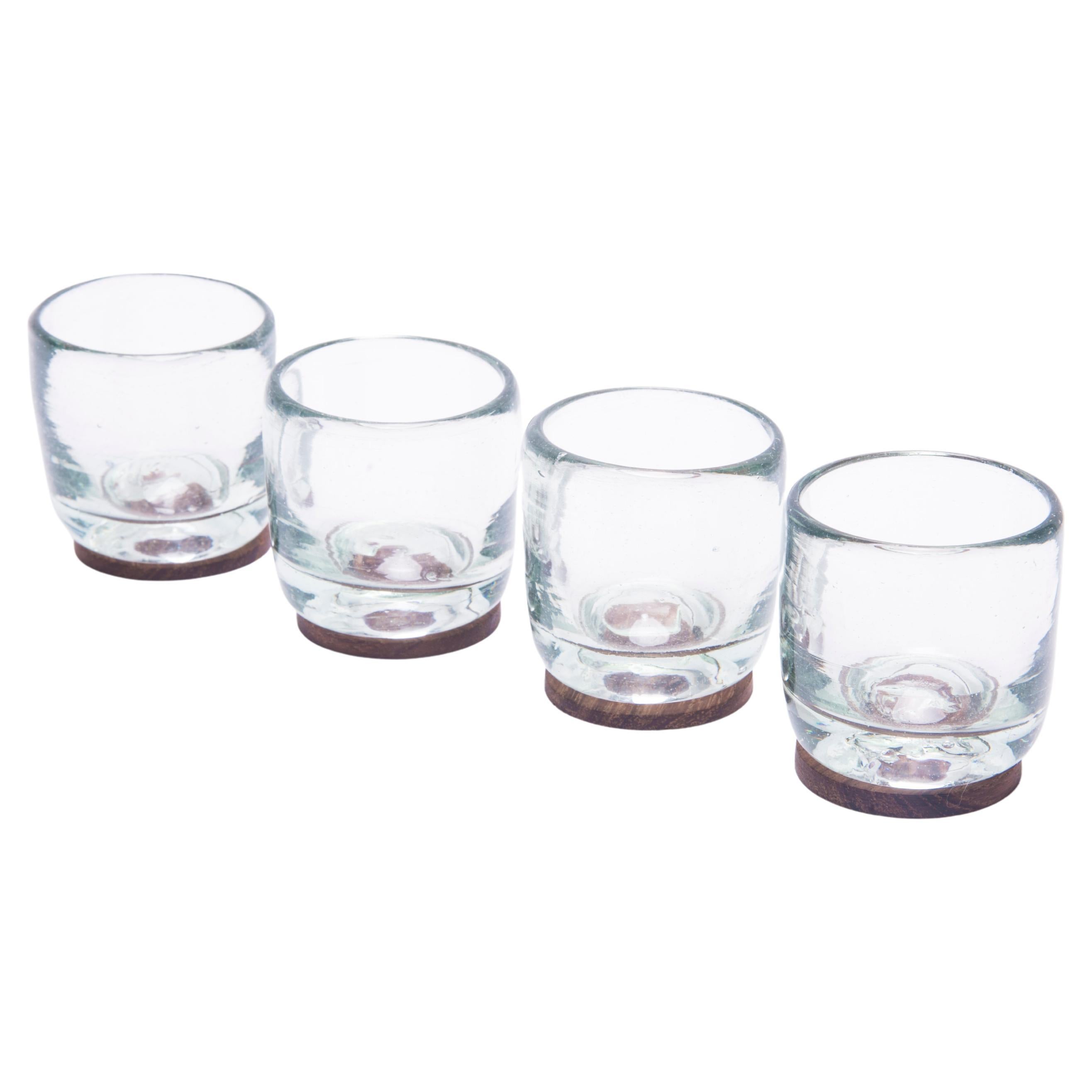 4 Piece Set of Transparent Hand Blown Shot Glasses with Parota Wood Coasters For Sale