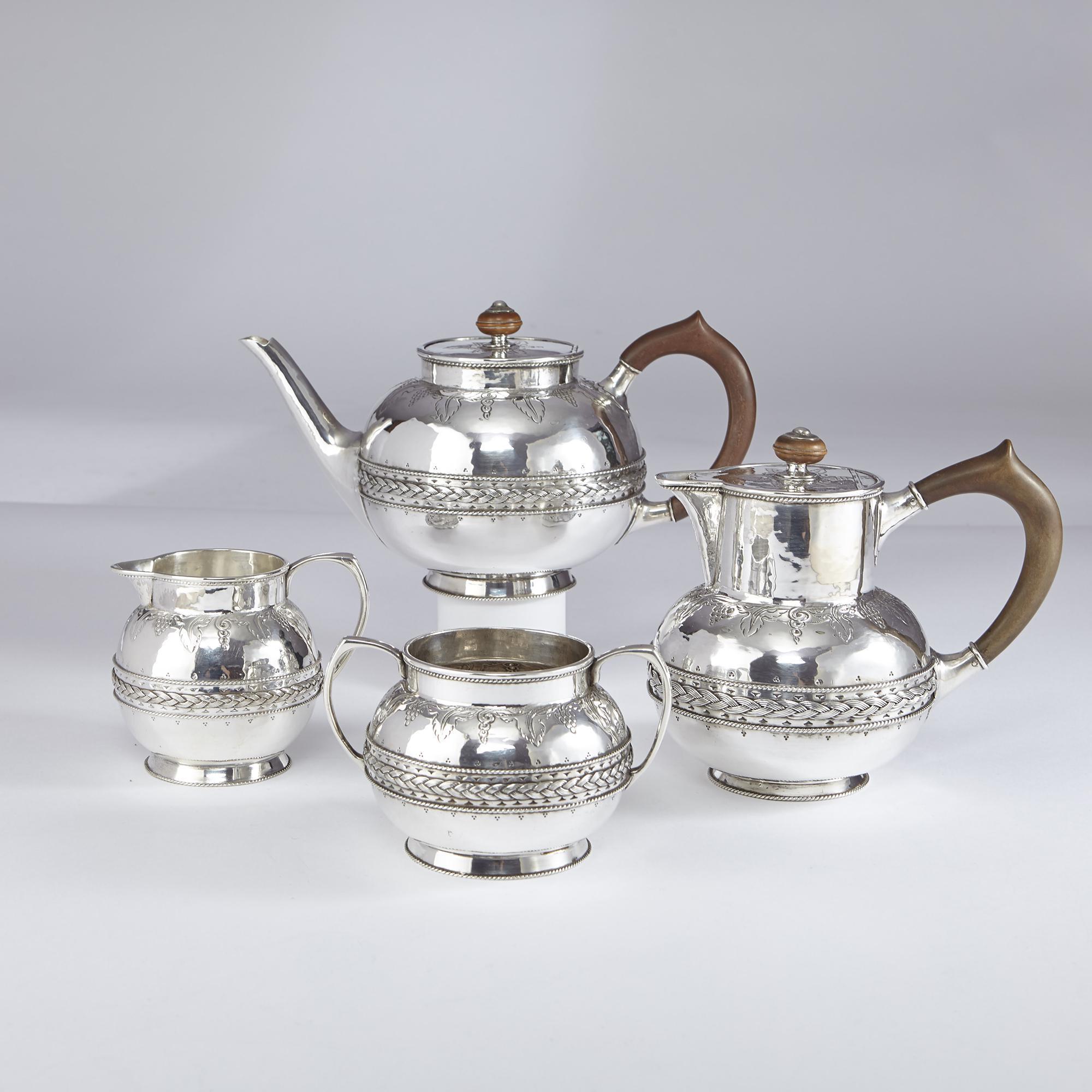 A hand-raised and hand-chased four-piece silver tea set, comprising a teapot, hot water jug, sugar bowl and milk jug. Each piece reflects its Arts & Crafts heritage with finely detailed cast and applied girdles of woven wirework patterns set against