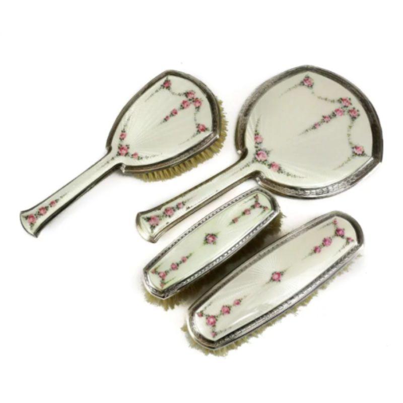 4 Piece Sterling Silver & Guilloche Enamel Vanity Set by R. Blackinton Company

The set includes a hand mirror, small clothes brush, large clothes brush, & hair brush. This vanity set contains an off white guilloche enamel with delicate pink rose