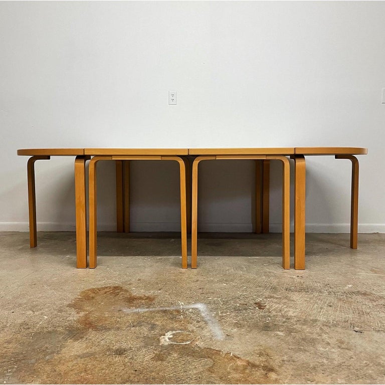 A four piece modular beechwood with white laminate top conference/dining table by Rud Thygesen and Johnny Sorensen for Magnus Olesen, Denmark. Label on underside. Each center section is 23.5 