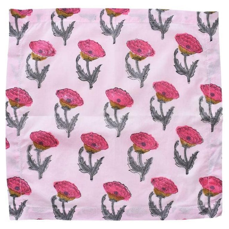 A set of new hand-made pink block print cloth table napkins. This beautiful set is hand-stitched by our artisans in Jaipur. Created from thin cotton fabric, this set has been hand dyed and block printed with bright pink flowers on green stems, on a