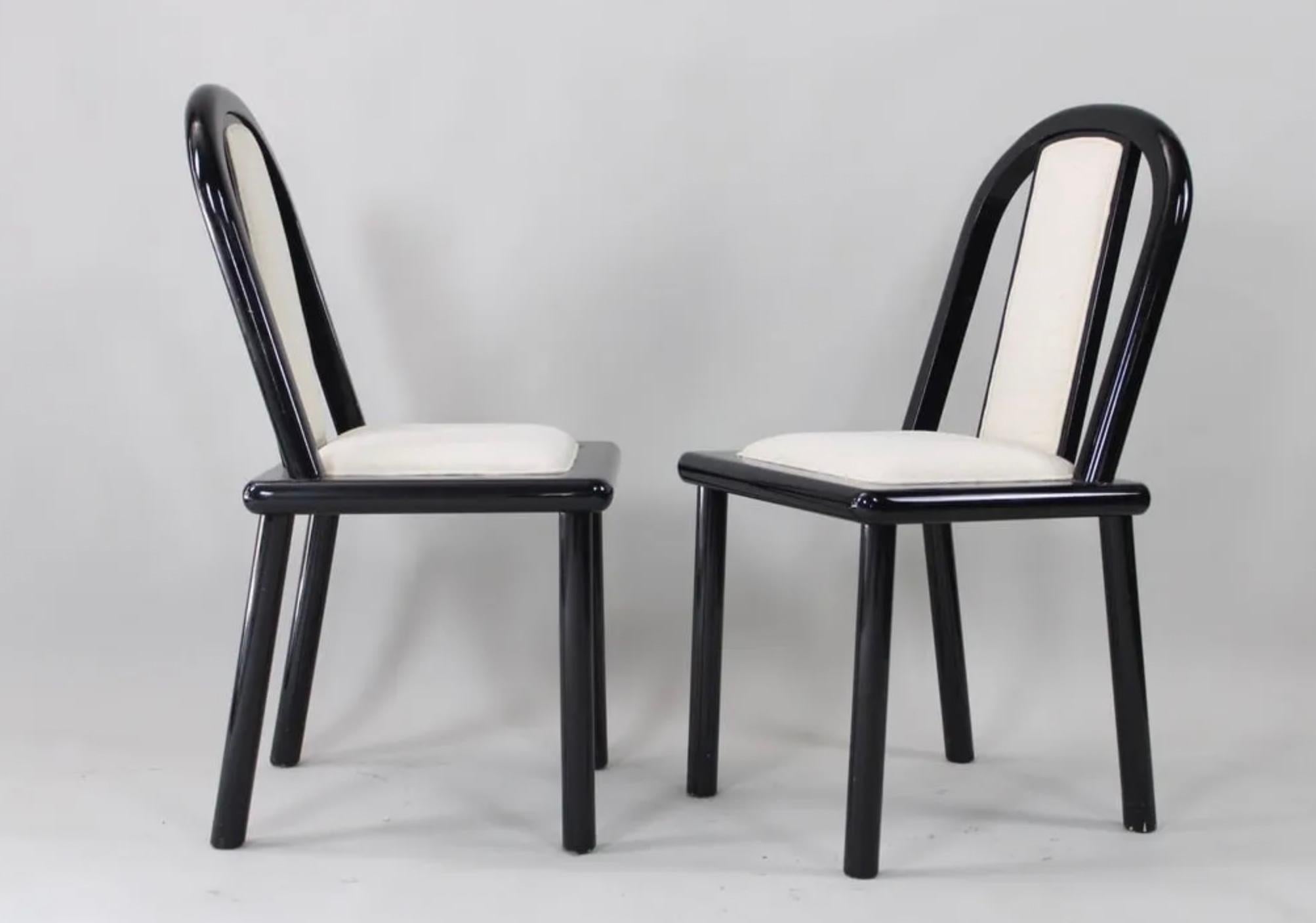 4 Post Modern Black Lacquer curved dining chairs Robert Mallet Stevens / Memphis Milano Style. Very unique set of (4) Dining chairs in good vintage condition. Black Lacquer painted wood frames with off-white upholstery. Made in USA Circa 1980.
