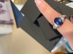 4 prong Platinum Set Oval Sapphire with Diamond Trillions on side Platinum Ring