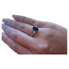 4 prong Platinum Set Oval Sapphire with Diamond Trillions on side Platinum Ring