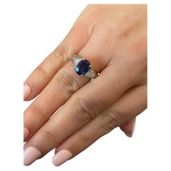 4 prong Platinum Set Oval Sapphire with Diamond Trillions on side Platinum Ring