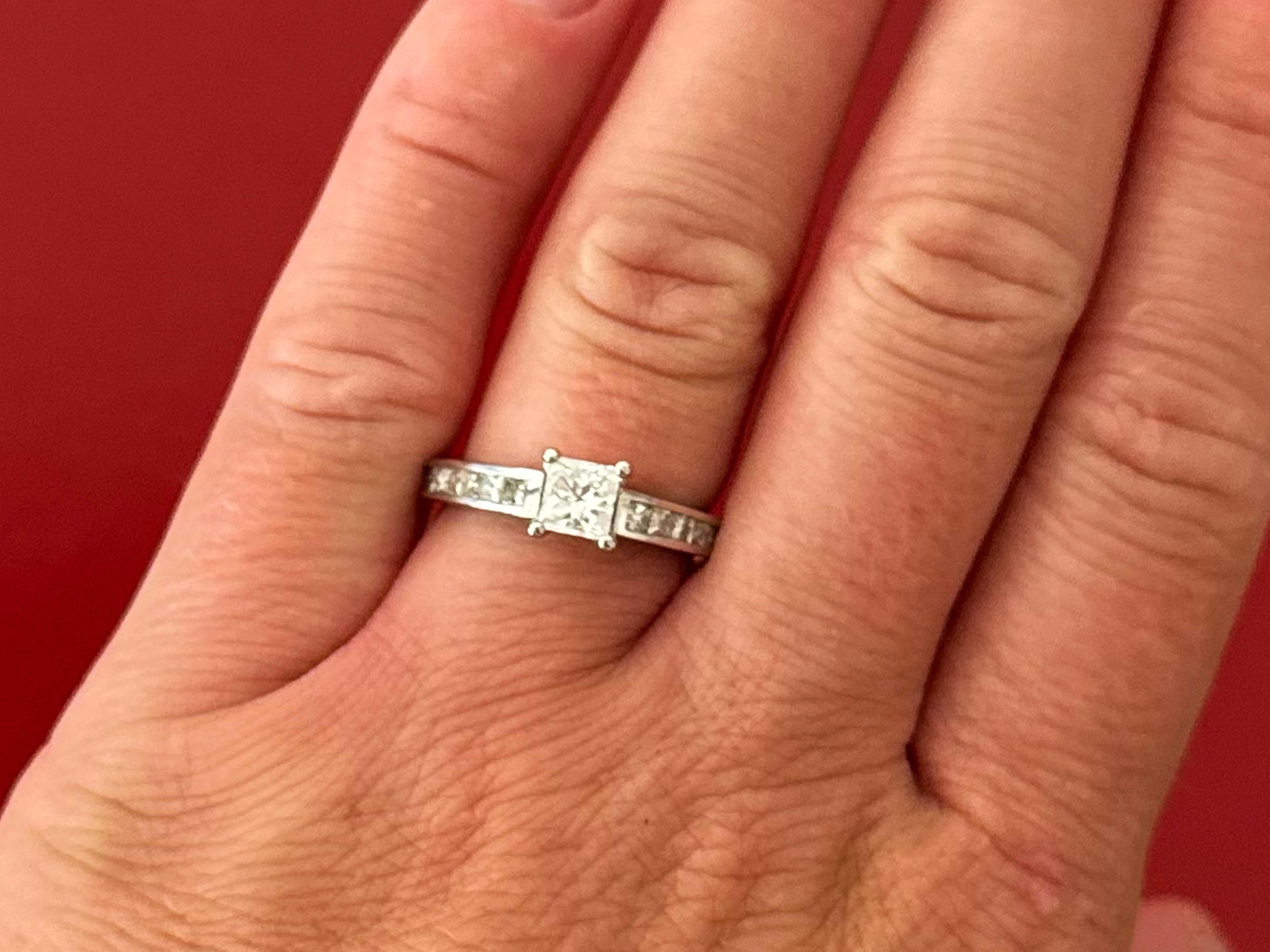 Item Specifications:

Metal: 14k White Gold 

Diamond Count: 1 princess cut center and 20 princess cut on shoulders
Total Diamond Carat Weight: ~1.15 carats (center stone is ~0.65 carats)

Diamond Color: I-J (all diamonds are I-J)

Diamond Clarity: