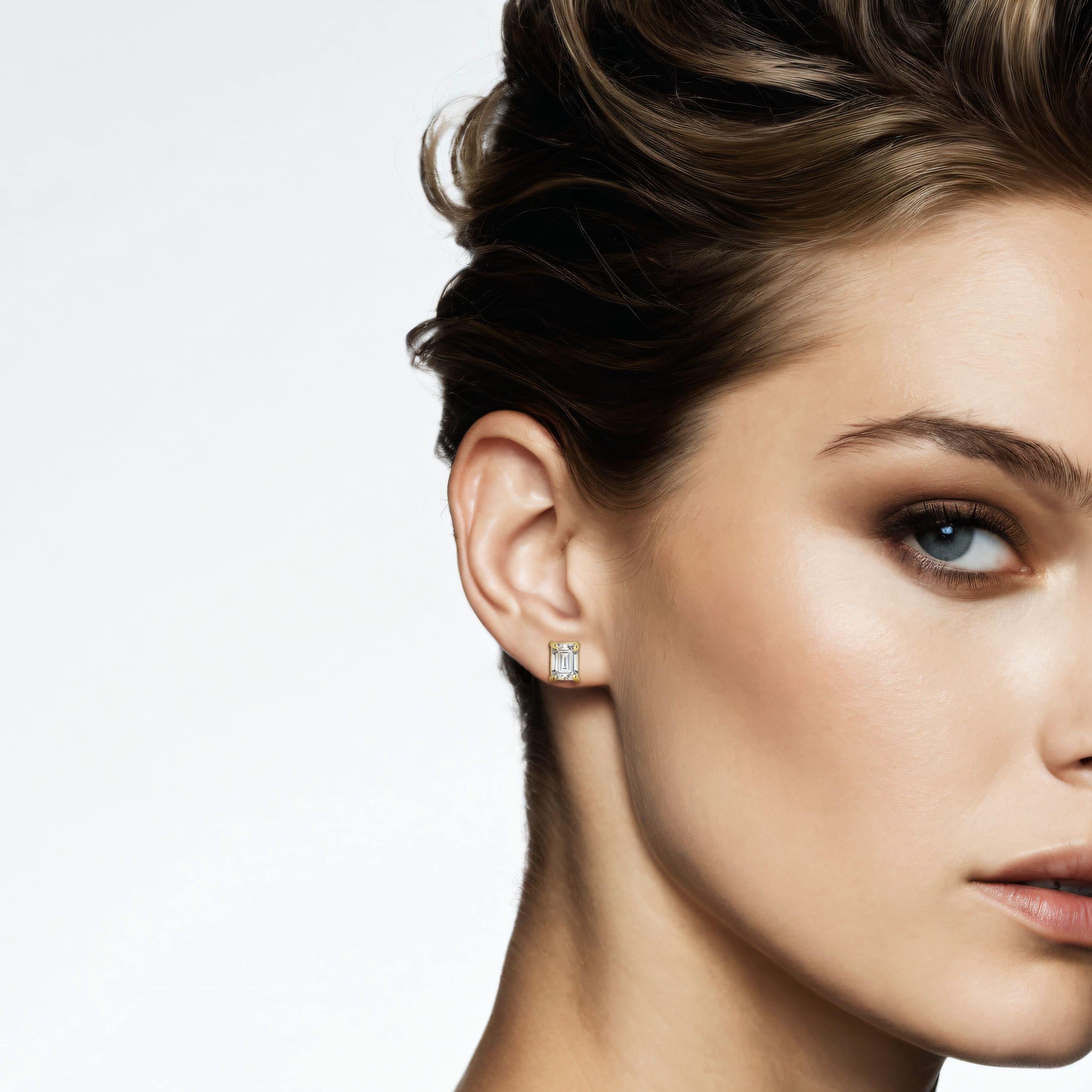 14k gold, each earring features a brilliant emerald-cut, conflict-free diamond, offering a sparkle that’s sure to turn heads. The secure Four prong screw back setting ensures comfort and durability, making them perfect for everyday wear or special