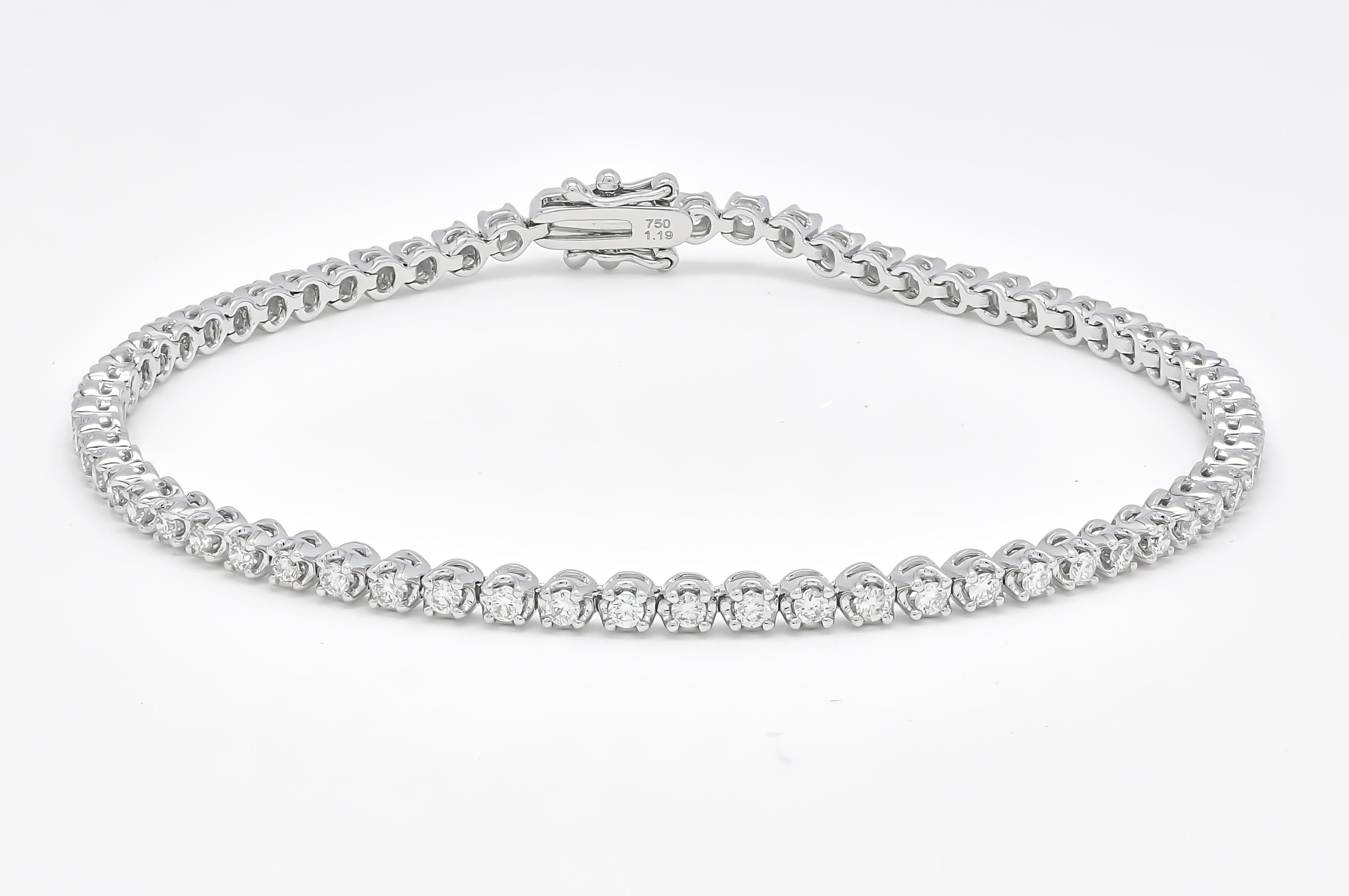 Elevate your style with this exquisite 18K White Gold Four Prong Tennis Bracelet. Crafted with meticulous attention to detail, it features a continuous line of dazzling round-cut natural diamonds, totalling 1.20 carats.

 Each diamond is expertly