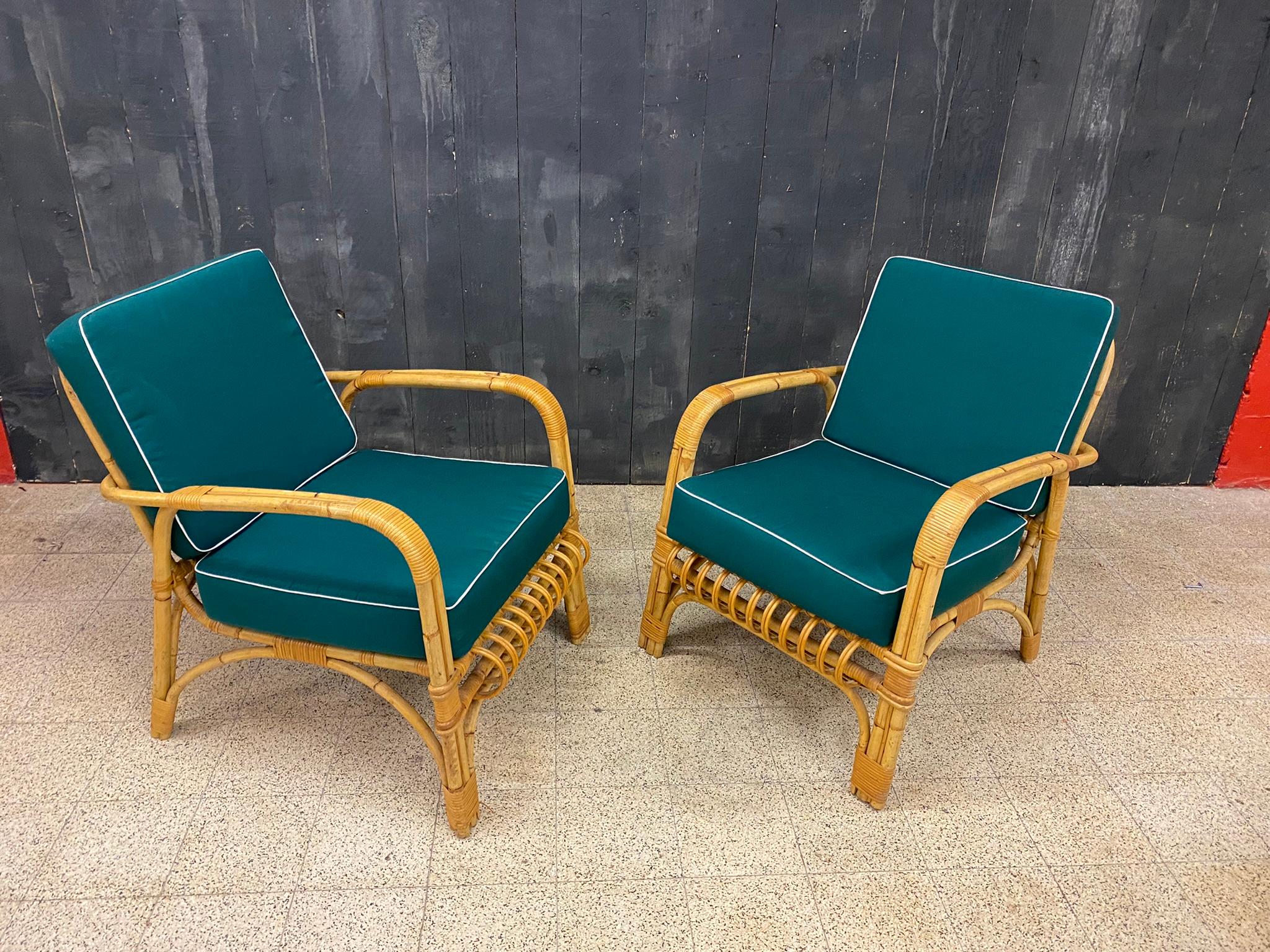 4 rattan armchairs and their cushions, circa 1970-1980.
2 sets of cushions are available, green and gray.