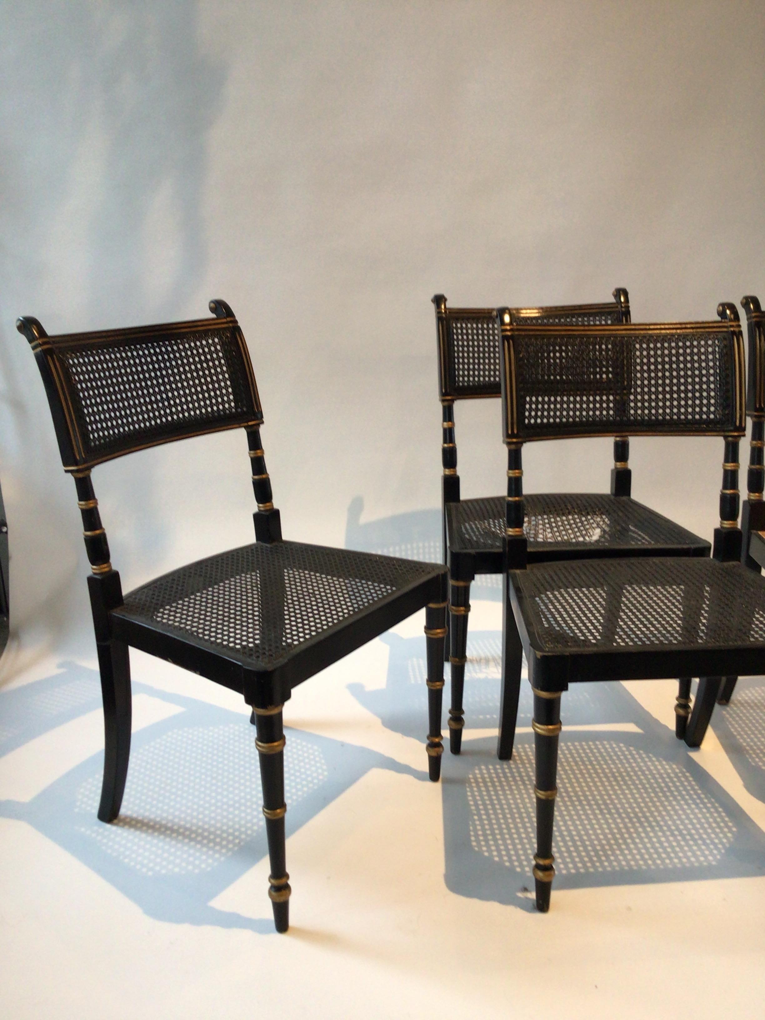 4 Baker Regency style caned chairs.