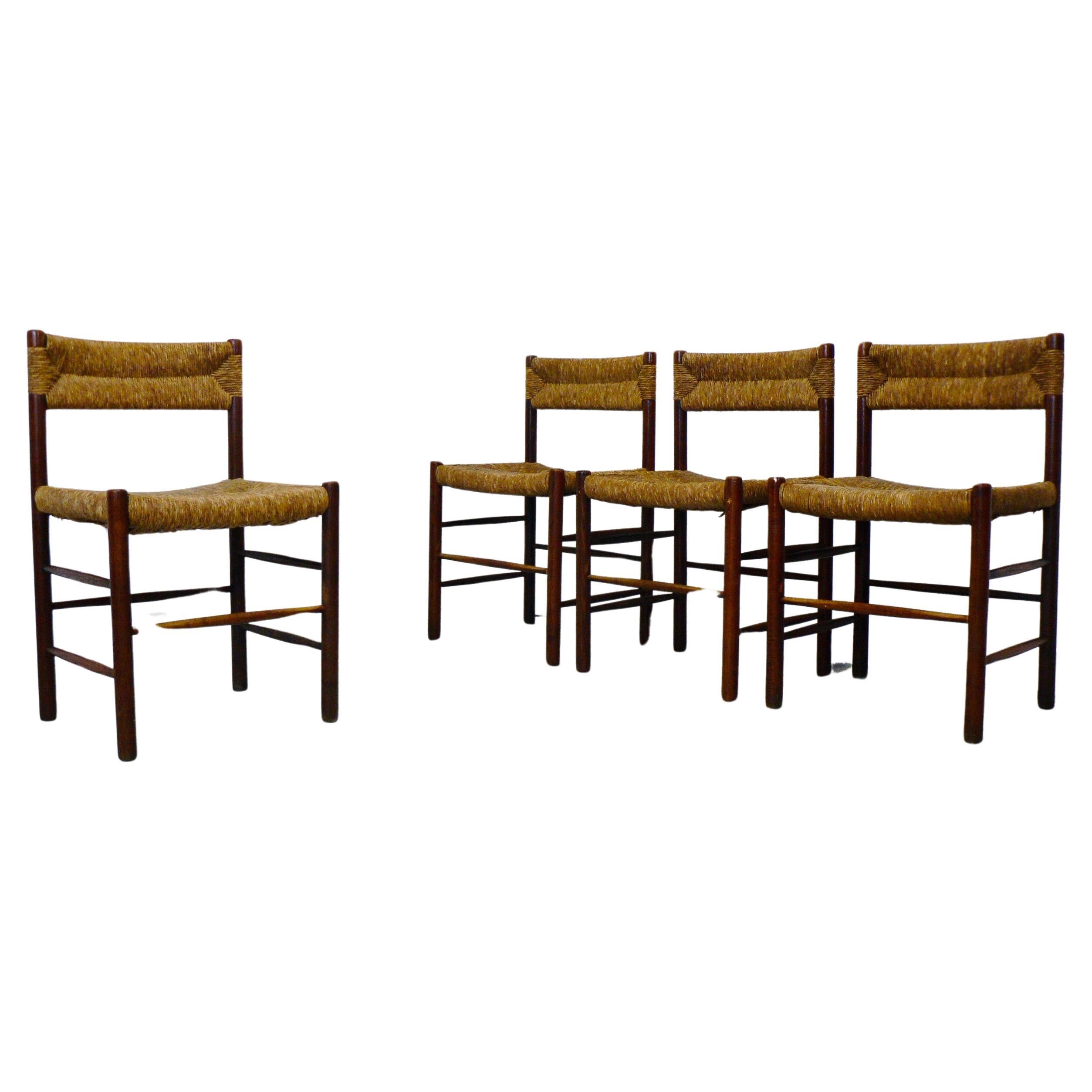 Set of four dining chairs designed by Robert Sentou for Sentou editions in the 1950s, and curated by Charlotte Perriand for various interior projects. 

The chairs feature a stained ashwood frame, consisting of sturdy, straight legs connected by