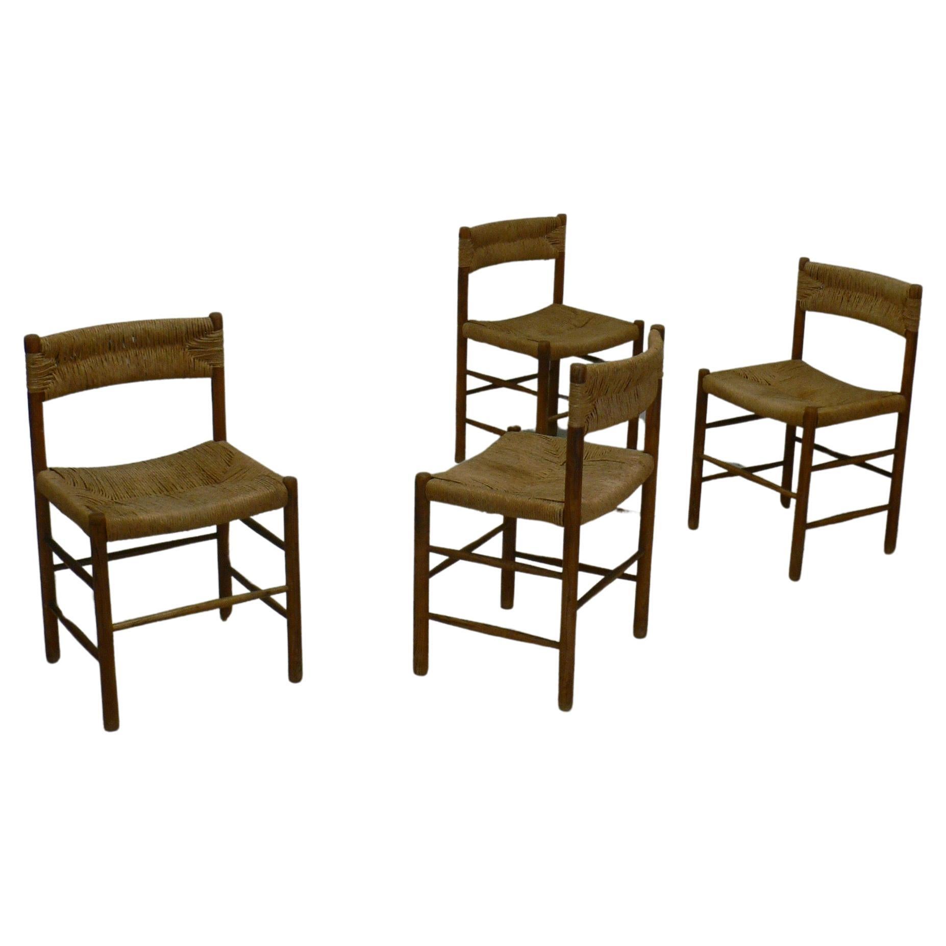 Set of four dining chairs designed by Robert Sentou for Sentou editions in the 1950s, and curated by Charlotte Perriand for various interior projects. 

The chairs feature a stained ashwood frame, consisting of sturdy, straight legs connected by