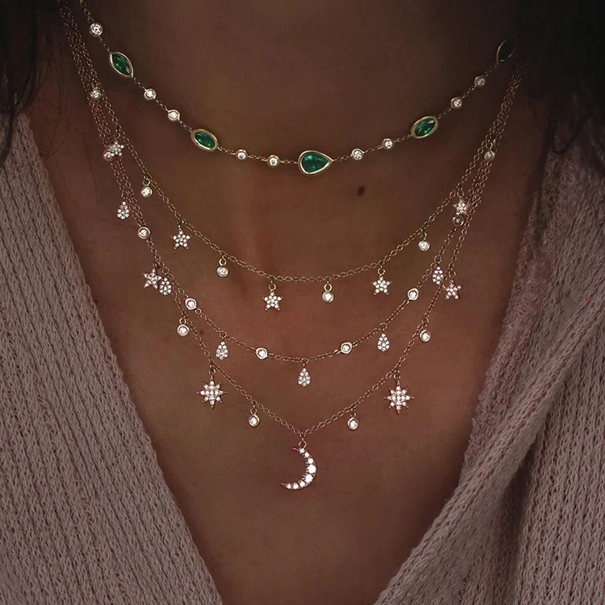 Simply Beautiful! Featuring a Necklace comprising 4 Cascading Rows of Crystals Gold Tone Multi Layer Pendant Necklaces. Enhanced with a row of Crystal Hearts. All in one Necklace! Hand crafted in Gold tone mounting. More Beautiful in real time! With