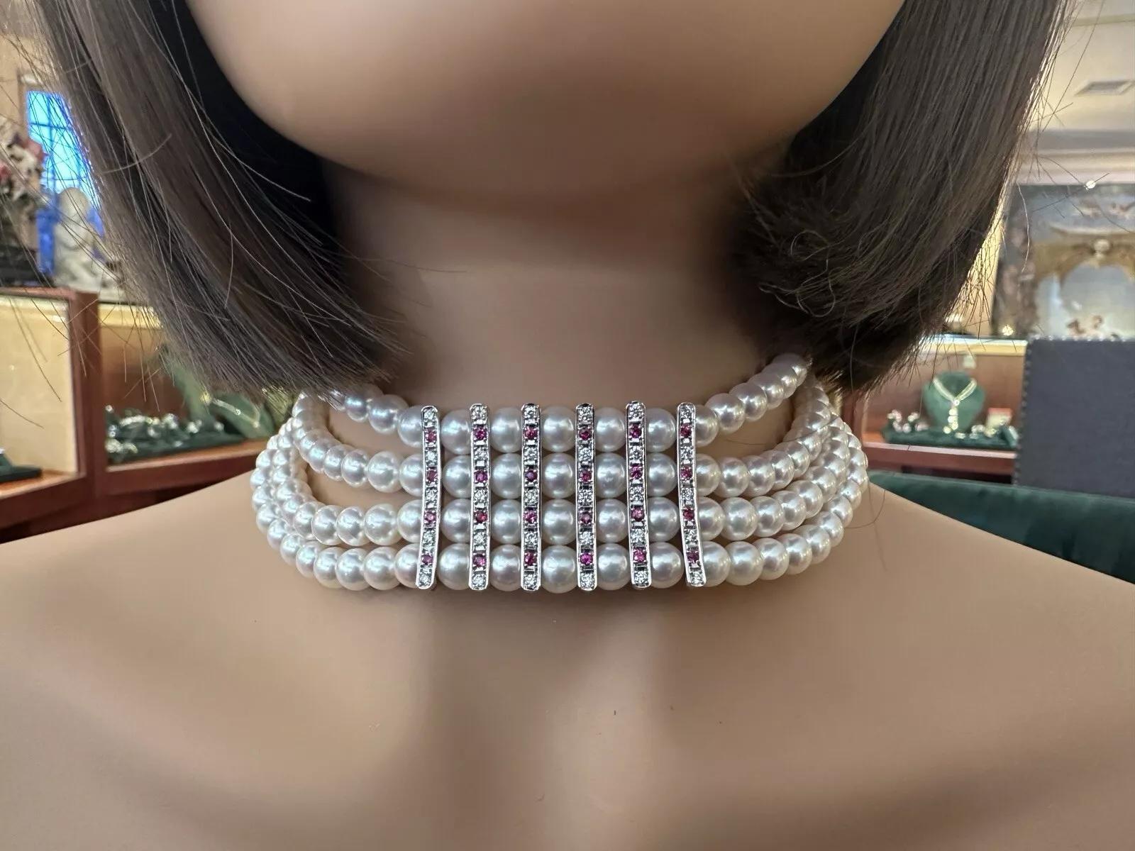 4 Row Pearl Choker Necklace with Rubies & Diamonds in Platinum

Pearl Choker Necklace features Four Strands of Cultured Pearls measuring 7-7.5mm and Cream color with Pink overtones and a very nice luster, accented with Wide Clasp with natural Round