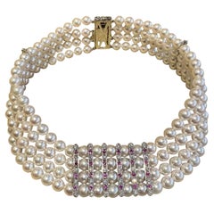 Collana girocollo a 4 file di perle con rubini e diamanti in platino