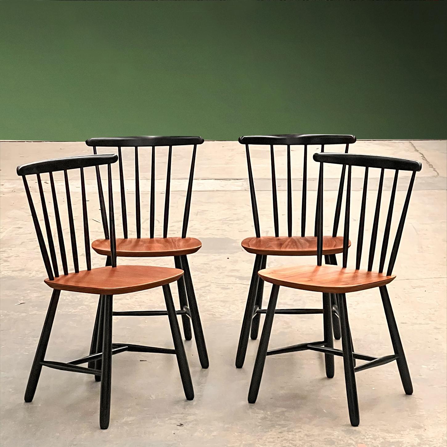 Set of four Scandinavian chairs in black lacquered wood with plywood seats and teak veneer. Danish design from the 1960s, in the style of Ilmari Tapiovaara's and his well known ‘Fanett’ model. This set of chairs is in good overall condition, with